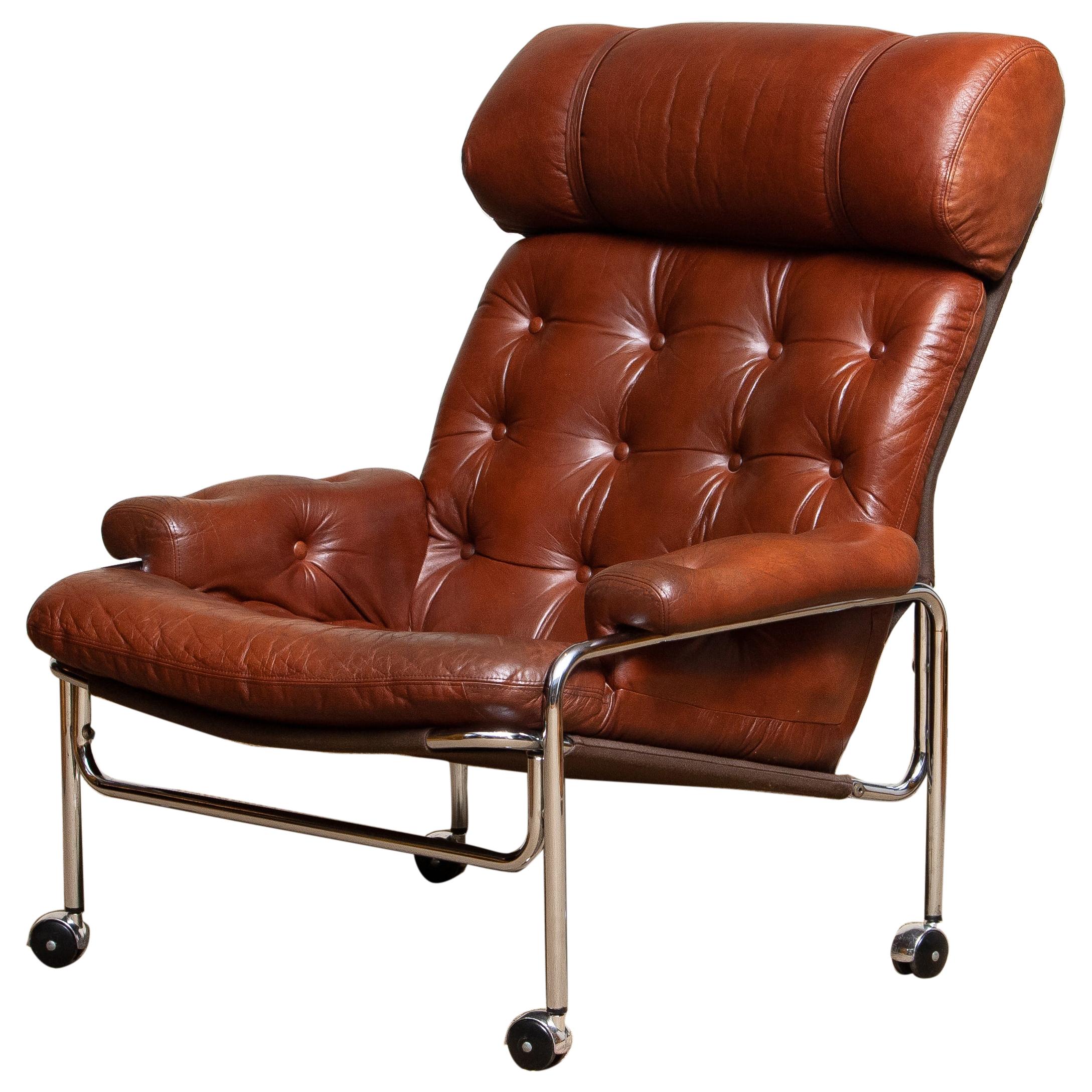 Beautiful lounge / easy chair in aged brown / cognac leather and chrome designed by Pethrus Lindlöfs for A.B. Lindlöfs Möbler Lammhult, Sweden.
The aged leather on the chairs gives the chairs the typical vintage character. The leather is soft and