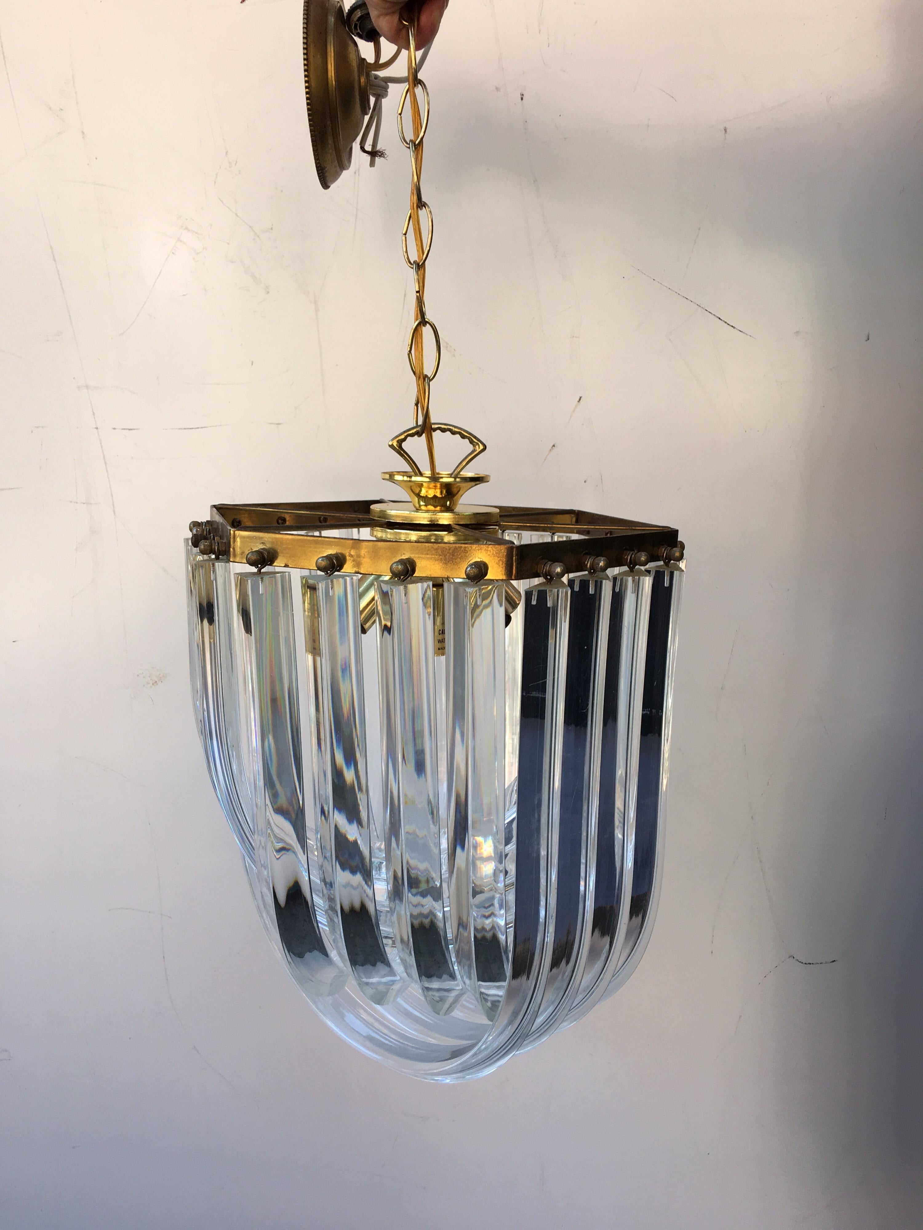 1960s-1970s cascading loop chandelier with brass trim. Comes with about a foot of chain.  2nd slightly larger version available as well!  Please inquire!  Larger one is 950.00