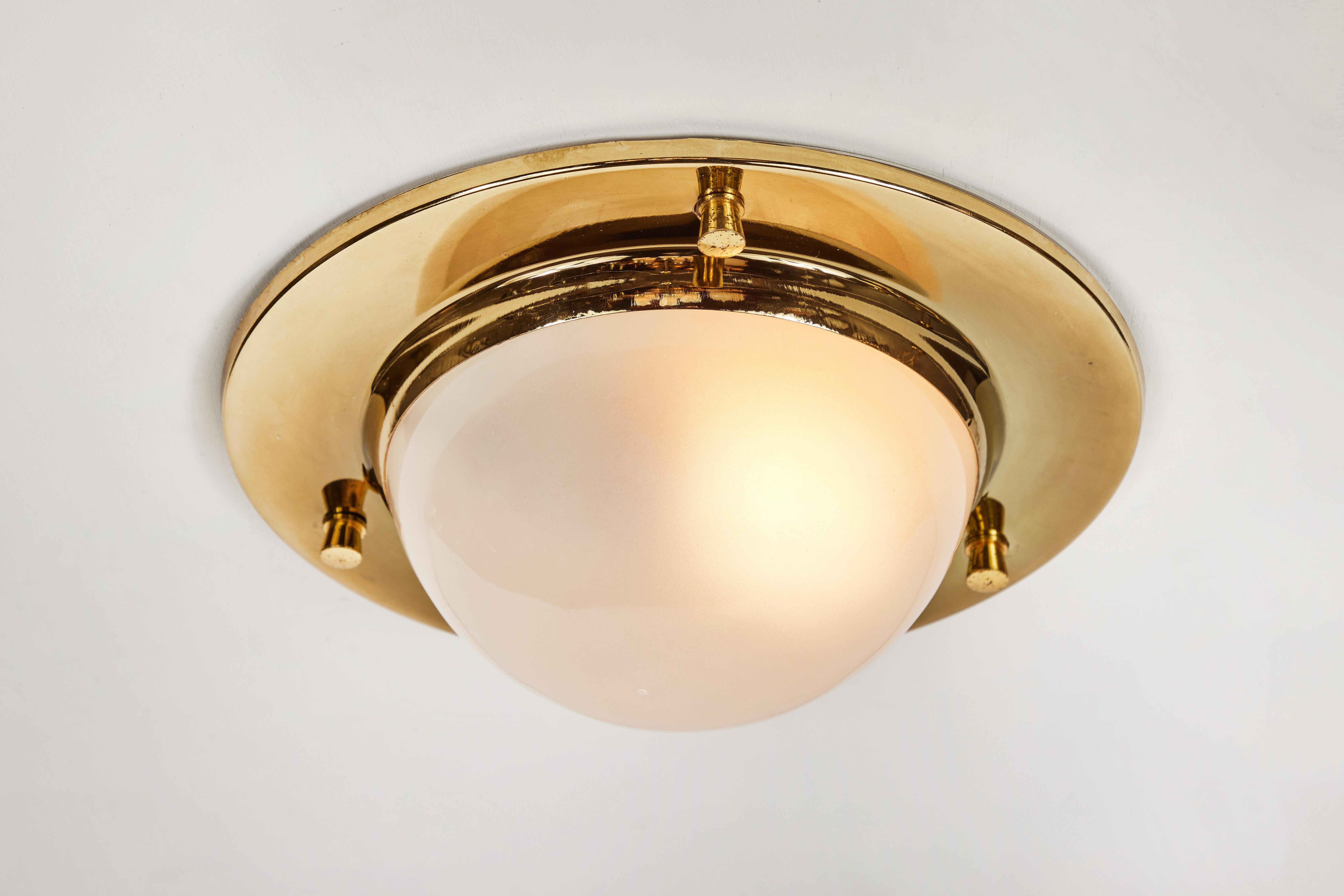 1960s Luigi Caccia Dominioni large 'Tommy' ceiling light for Azucena. An iconic design executed in brass and opaline glass, Italy, circa 1965.

Azucena was one of the most innovative lighting design companies in Italy during the midcentury era,