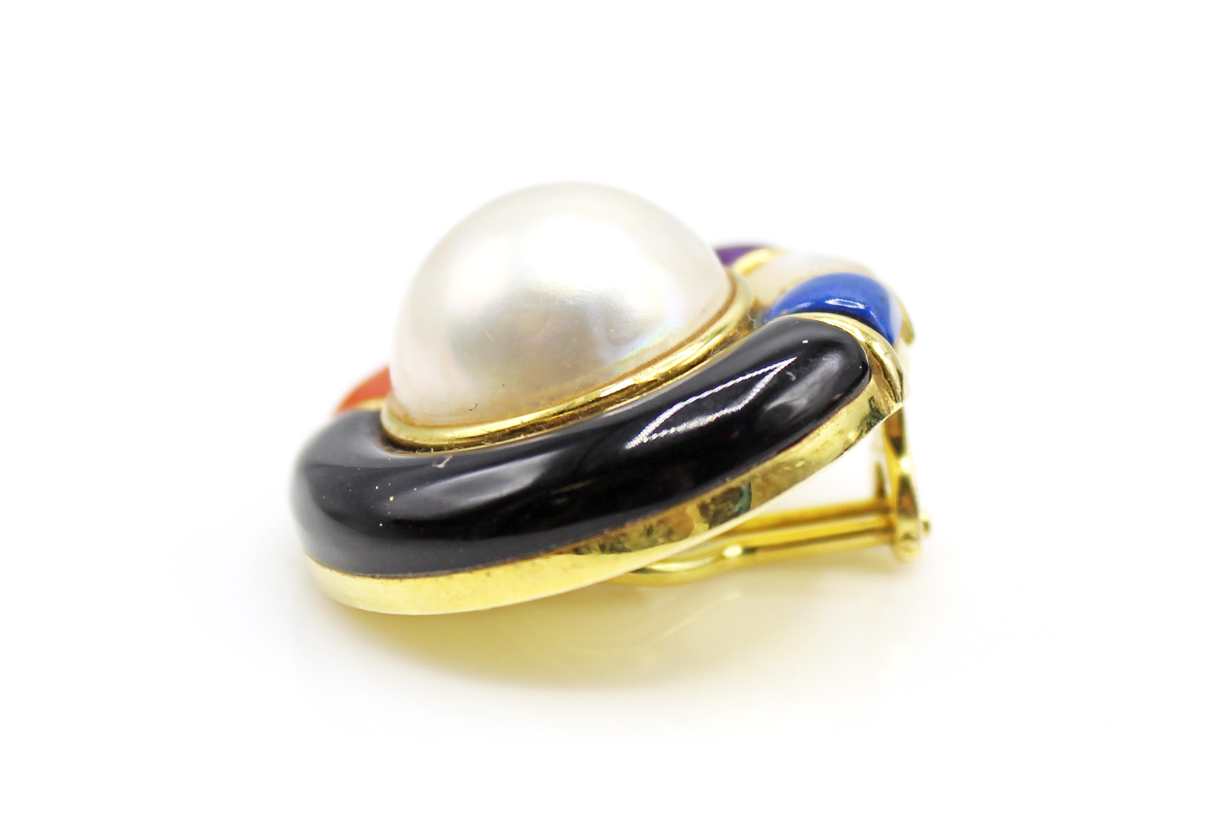 These amazingly well hand-crafted 1960s ear clips were designed in a round form with a thin border of high polished gold. The center piece features a wonderful white lustrous mabe pearl, bezel set and further surrounded by onyx, lapis lazuli,