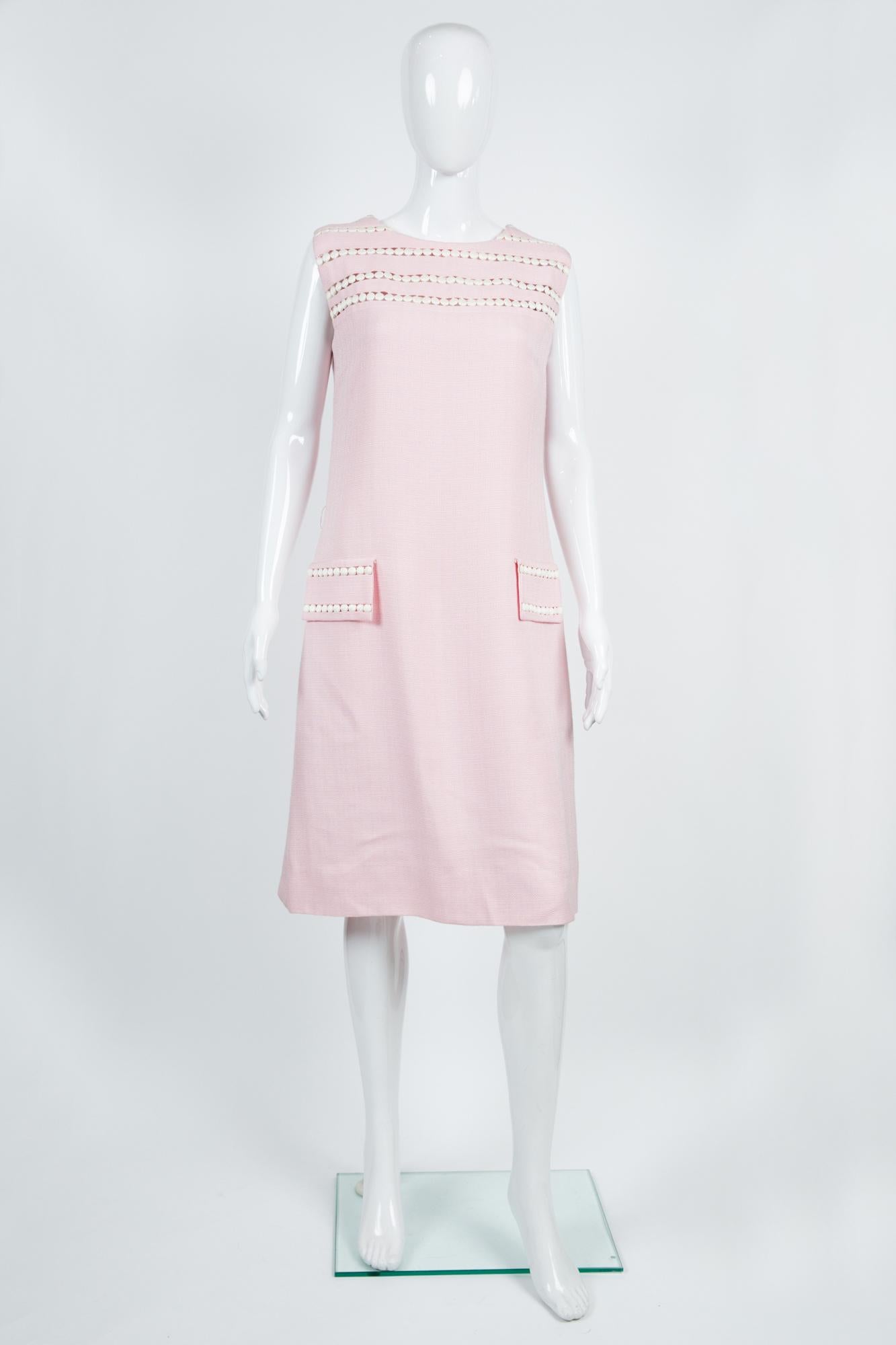 Maggy Rouff pink silk dress featuring a white ribbon detail, a center back zip opening, a silk lining. 
Label: Maggy Rouff - 14 Avenue Montaigne Paris, circa 1968/1970
Estimated size 40fr/US8/UK12
In good vintage condition
We guarantee you will