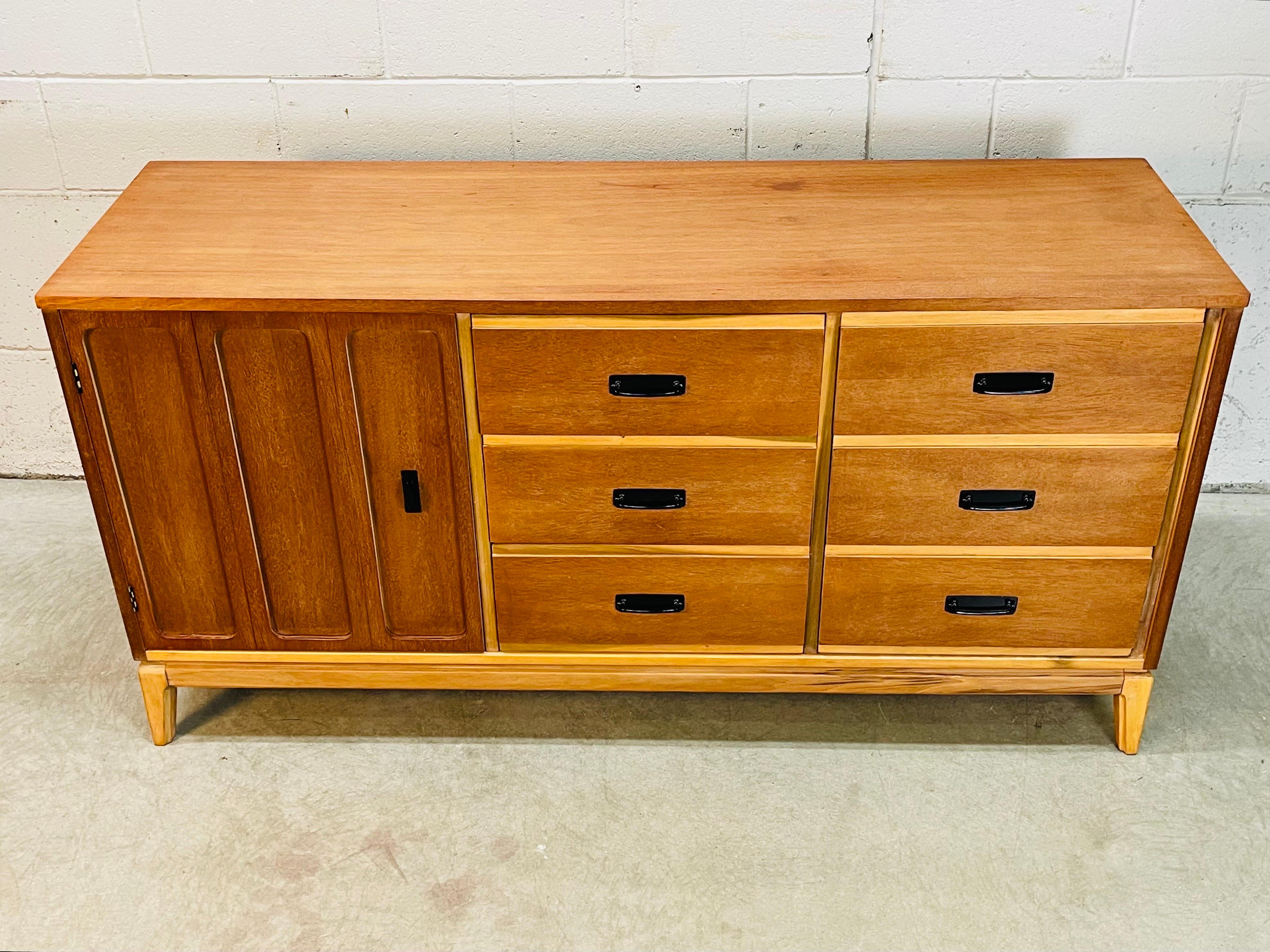 Vintage 1960s Mainline by Hooker Furniture low dresser with nine drawers. The dresser is a mix of walnut and ash woods. The drawers measure 5”H and is marked inside the drawer. The dresser is solid and sturdy. Newly refinished condition.