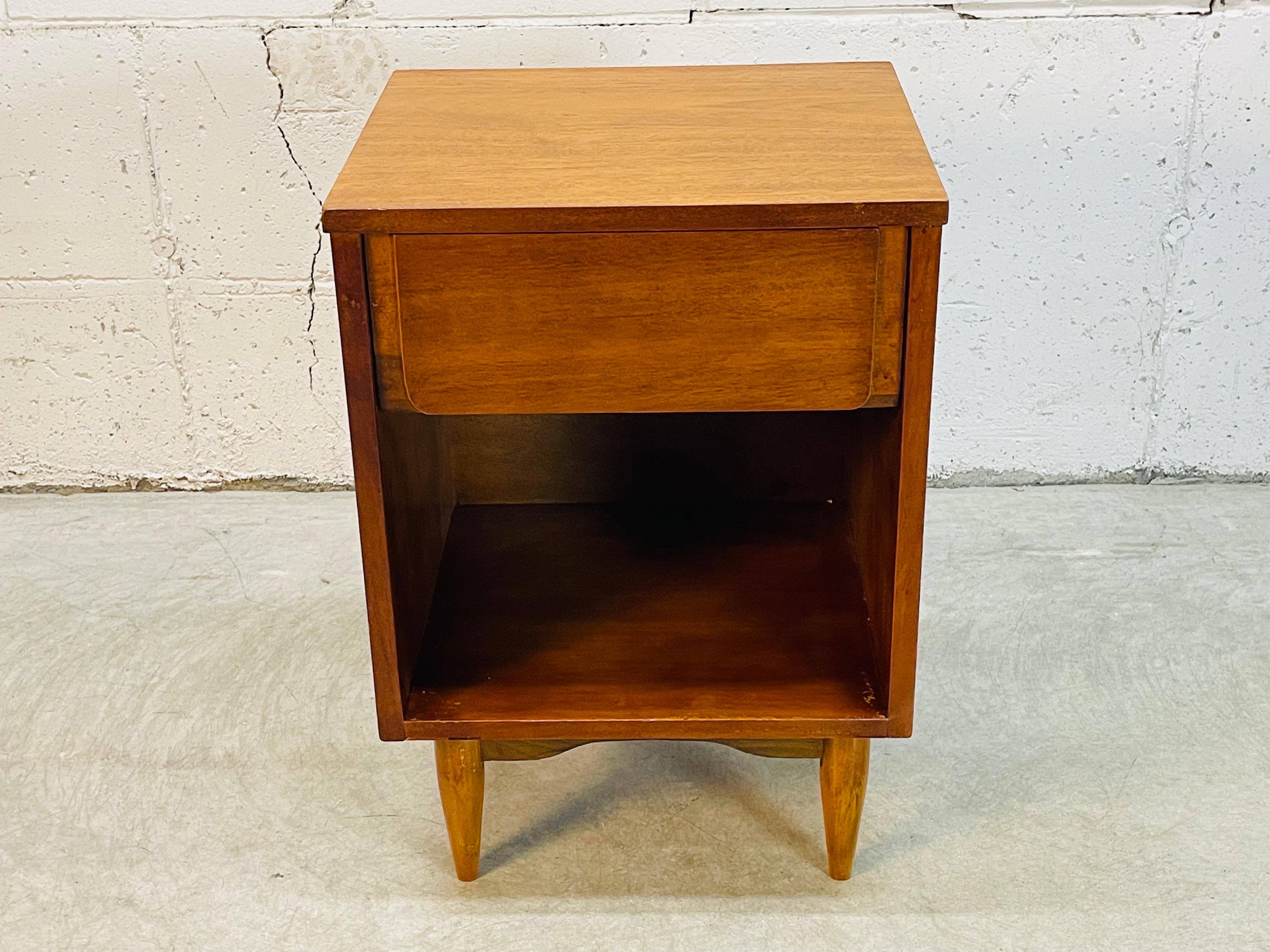 Vintage 1960s Mainline by Hooker Furniture walnut wood single drawer nightstand. The nightstand has open storage underneath and is marked inside the drawer. Newly refinished condition.