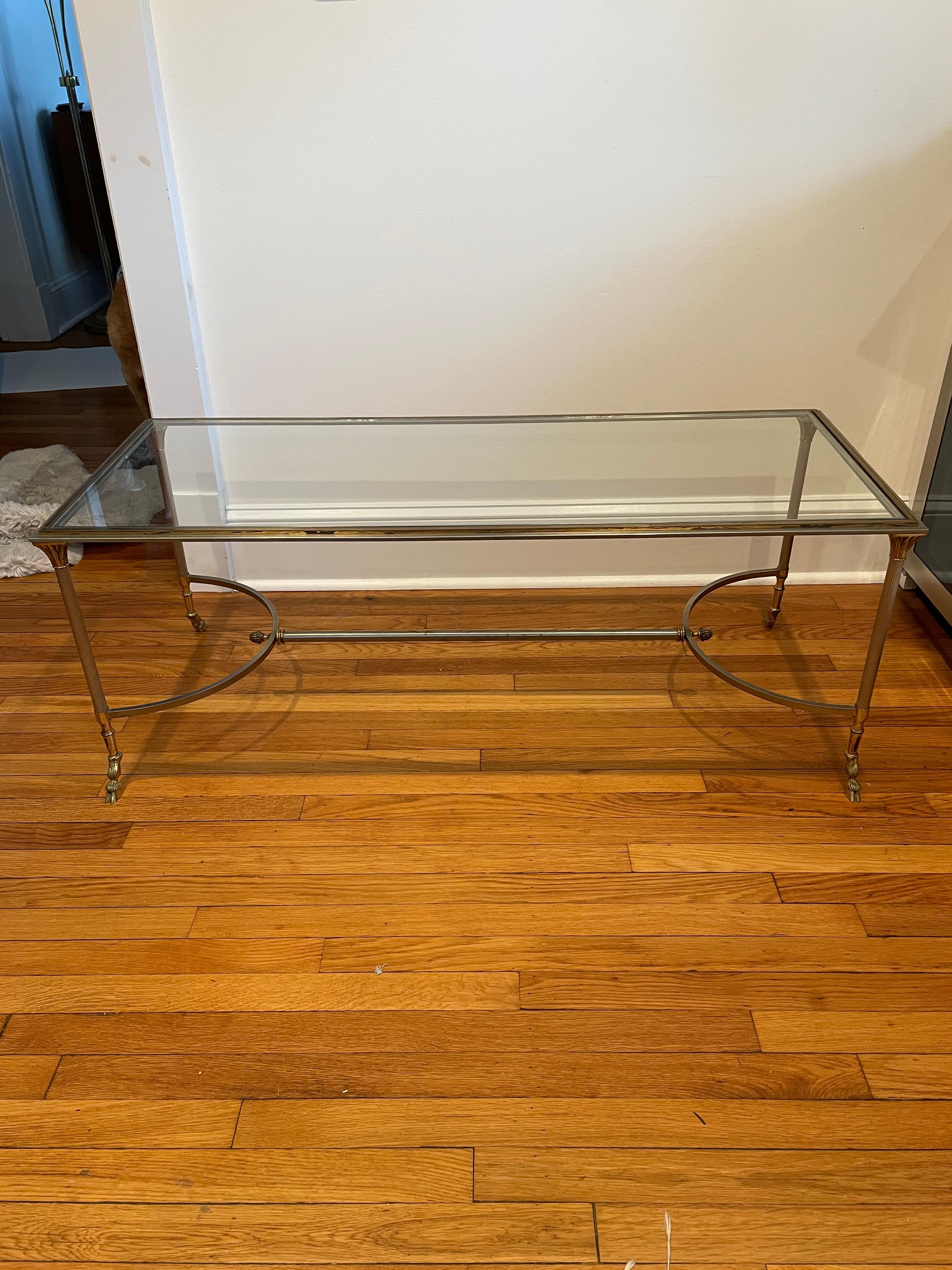 Classic steel and brass cocktail or coffee table in the manner of Maison Charles. Hoof feet.