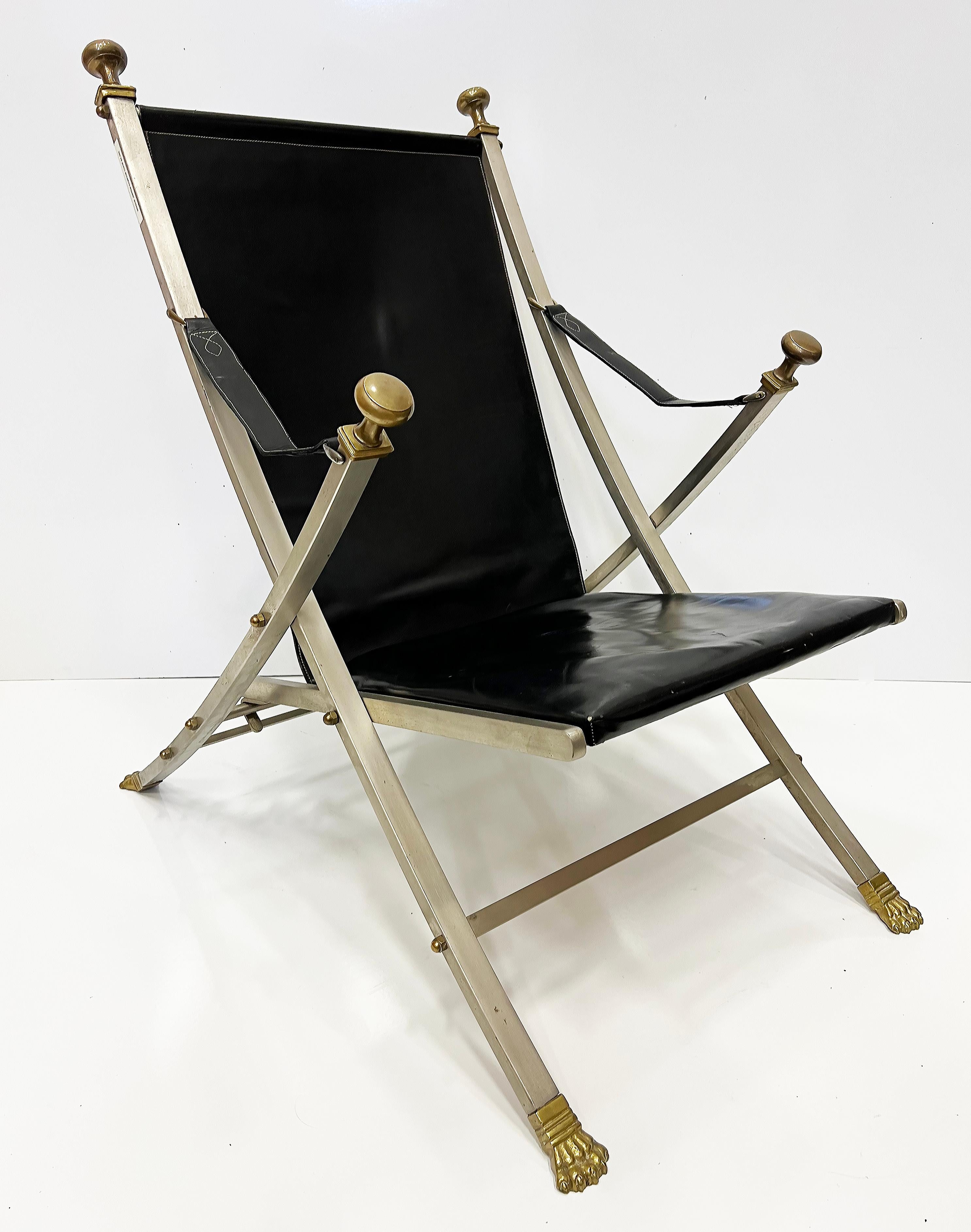 1960s Maison Jansen Steel, Bronze, Leather Campaign Chair

Offered for sale is an elegant original 1960s brushed steel, bronze, and leather campaign chair designed by Otto Parzinger for Maison Jansen.
The chair is a modern interpretation of a
