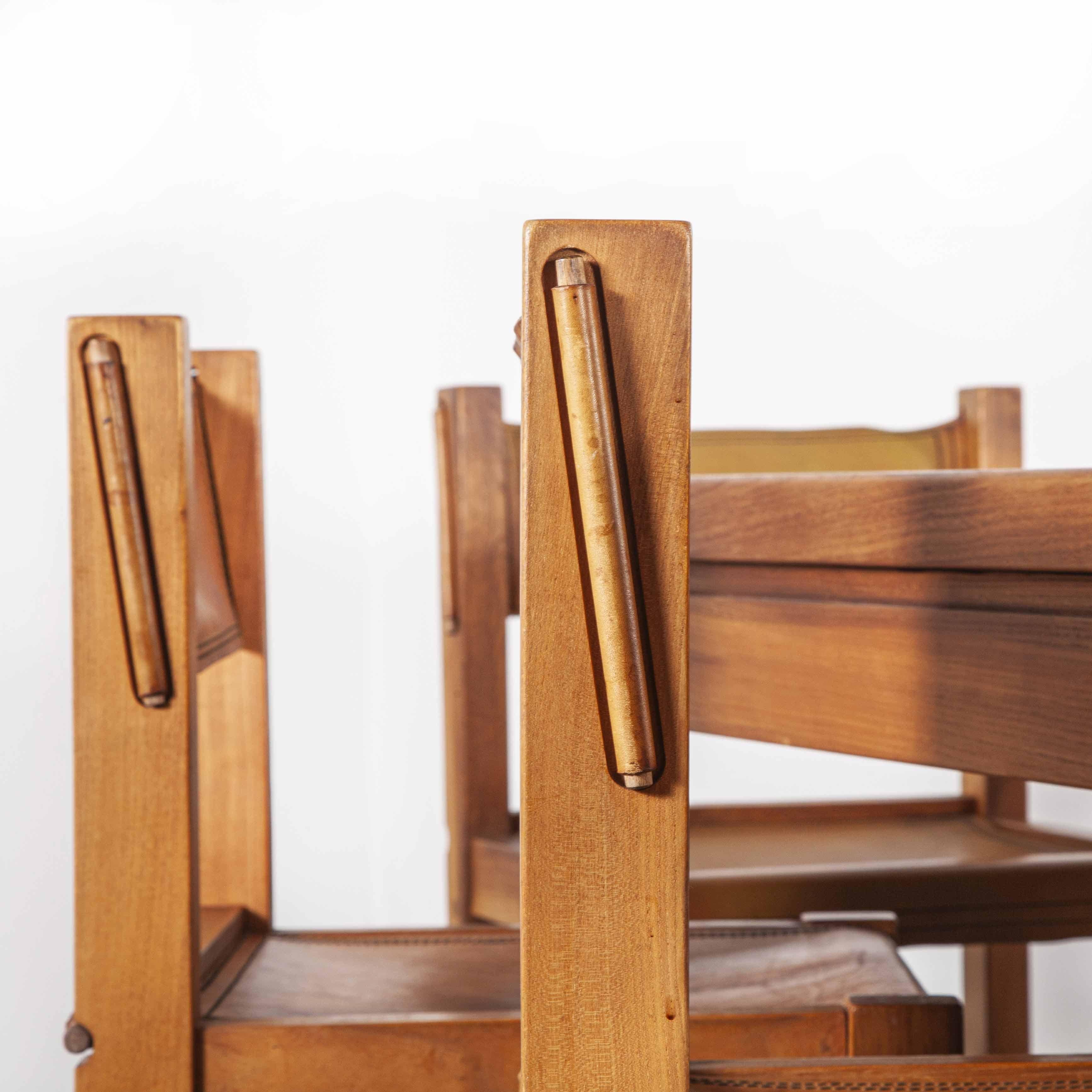 1960s Maison Regain elm large rectangular dining table and eight leather chair set. At their height of success in the 1960s, Maison Regain was considered the market leader for modernist furniture much inspired by the work of Pierre Chapo. This set