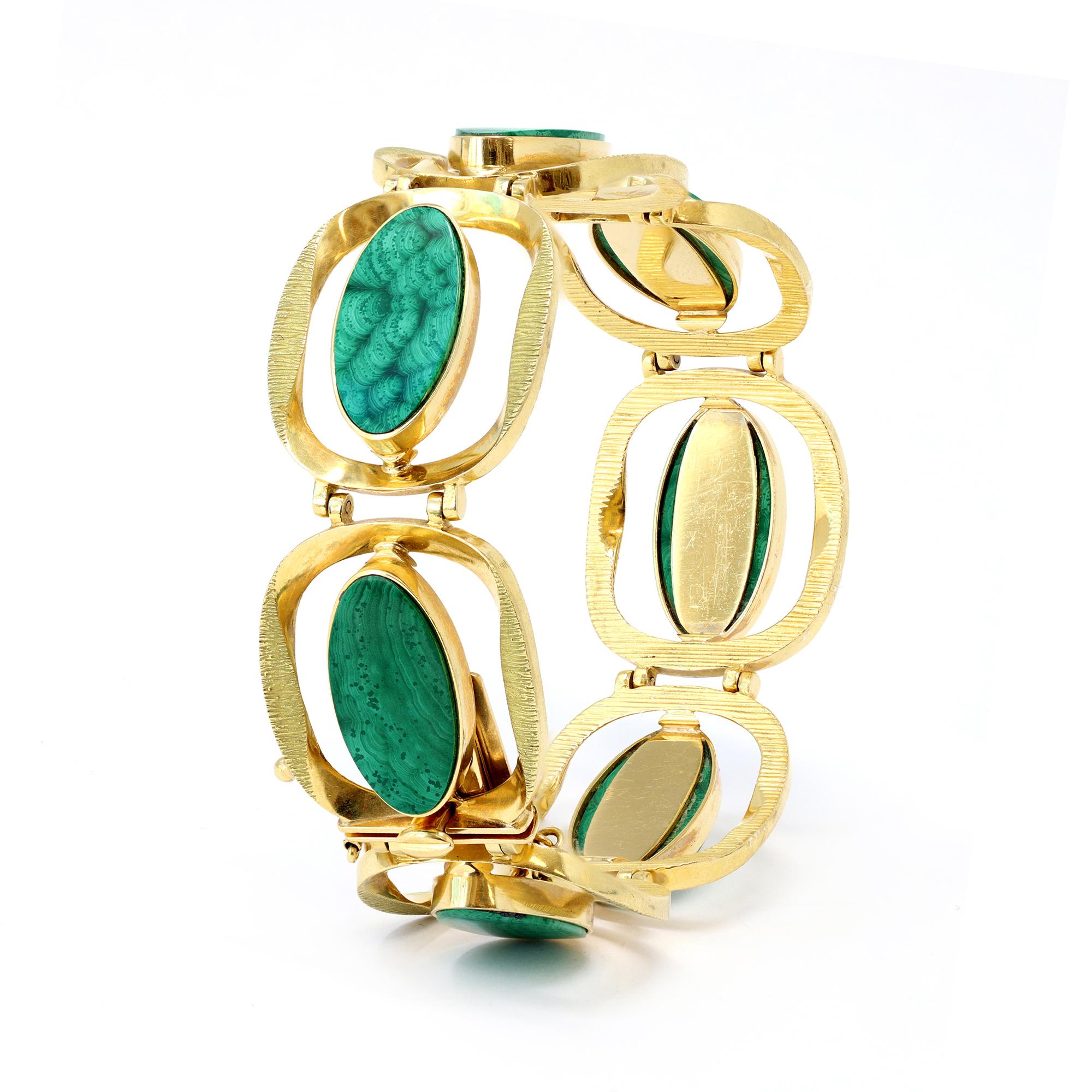 Yellow gold and malachite bracelet, circa 1960, designed as a series of semi circular textured gold links set in the center with oval malachite sections. The gross weight of the bracelet is 63.5 grams, with a length of 7 ½ inches, and it is 1 inch