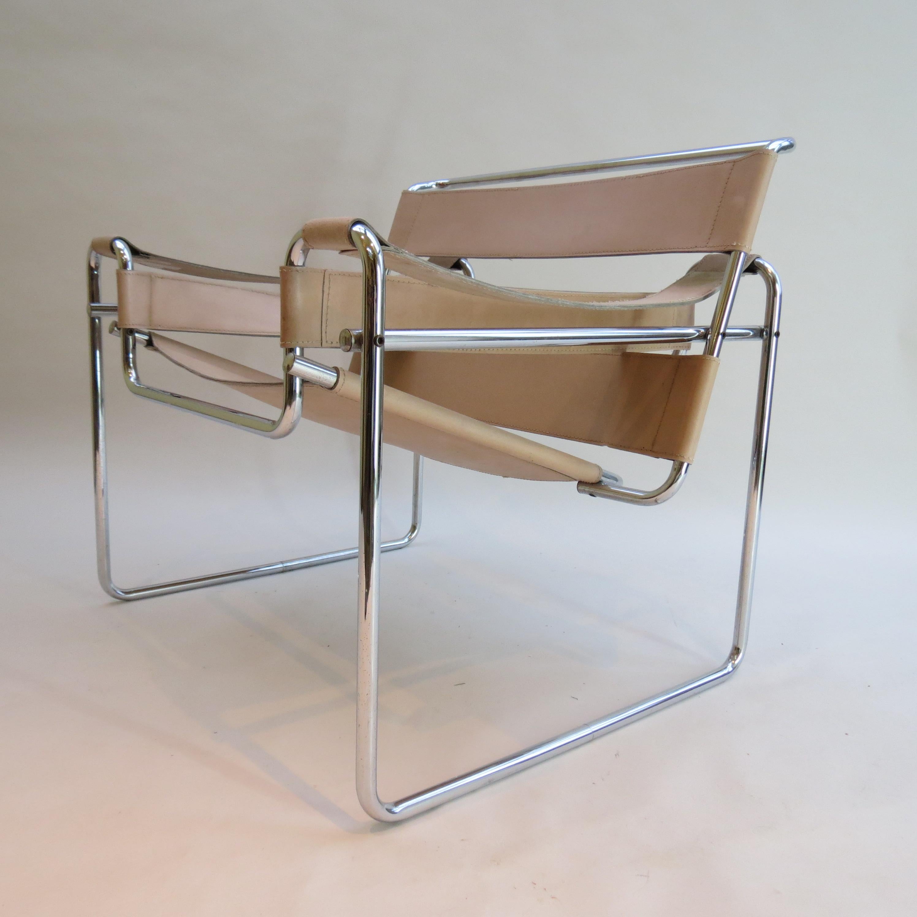 A Wassily chair designed by Marcel Breuer and manufactured by Gavina, Italy. This chair dates from 1968–1972, original year of design 1925.
Polished chrome tube with cream leather seat and arms. In good overall condition, some wear to the leather
