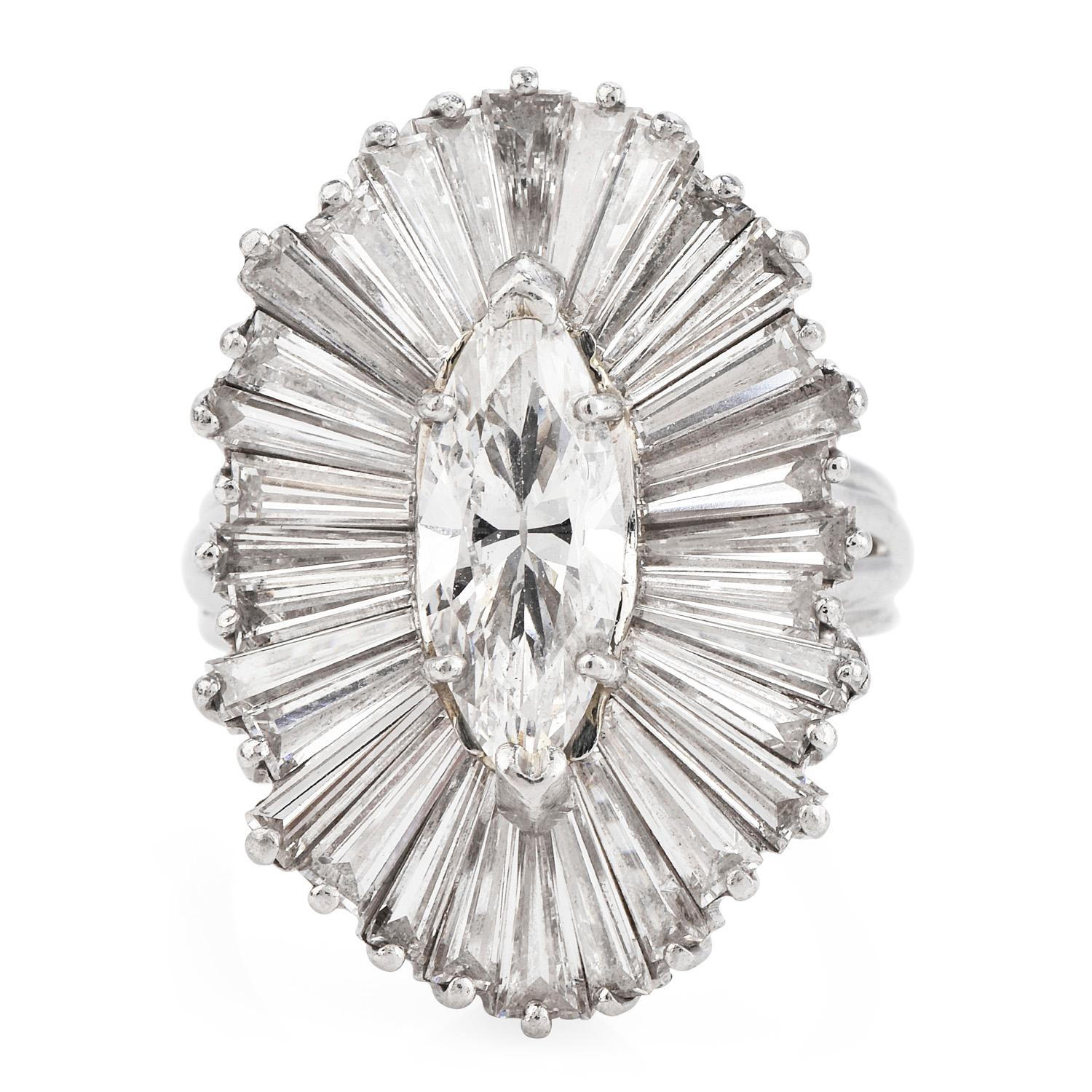 Dazzling with pure diamond  Cocktail cluster ring.  

Crafted in Platinum, ballerina style setting, and featuring in the center with one marquise-shaped diamond measuring 12.5mm 5.25mmx 4.1mm, weighing approx. 1.41 carats and approx 30 baguette-cut