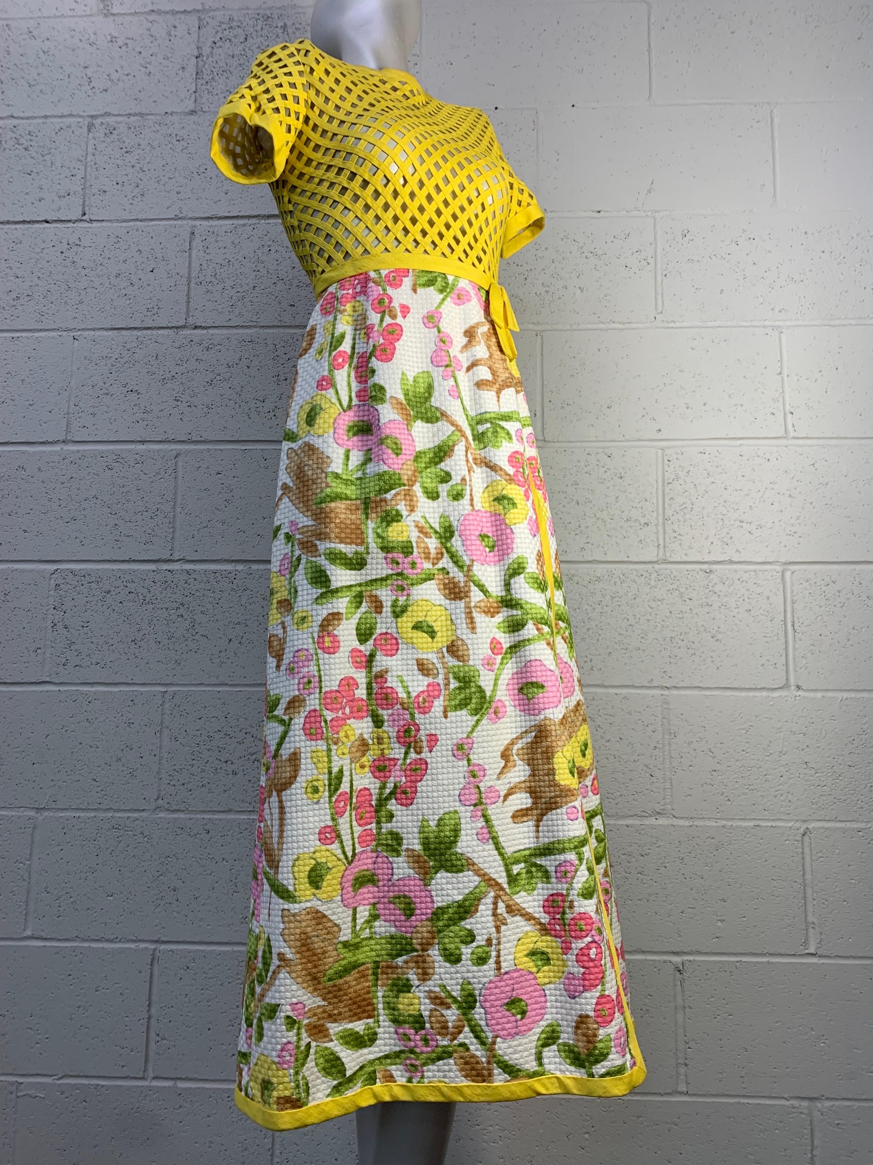 A wonderful 1960s Martha hostess gown with lemon yellow trellis-work short-sleeved bodice and a cotton pique floral print wrap skirt edged in matching yellow piping. Fully lined. Size 4.