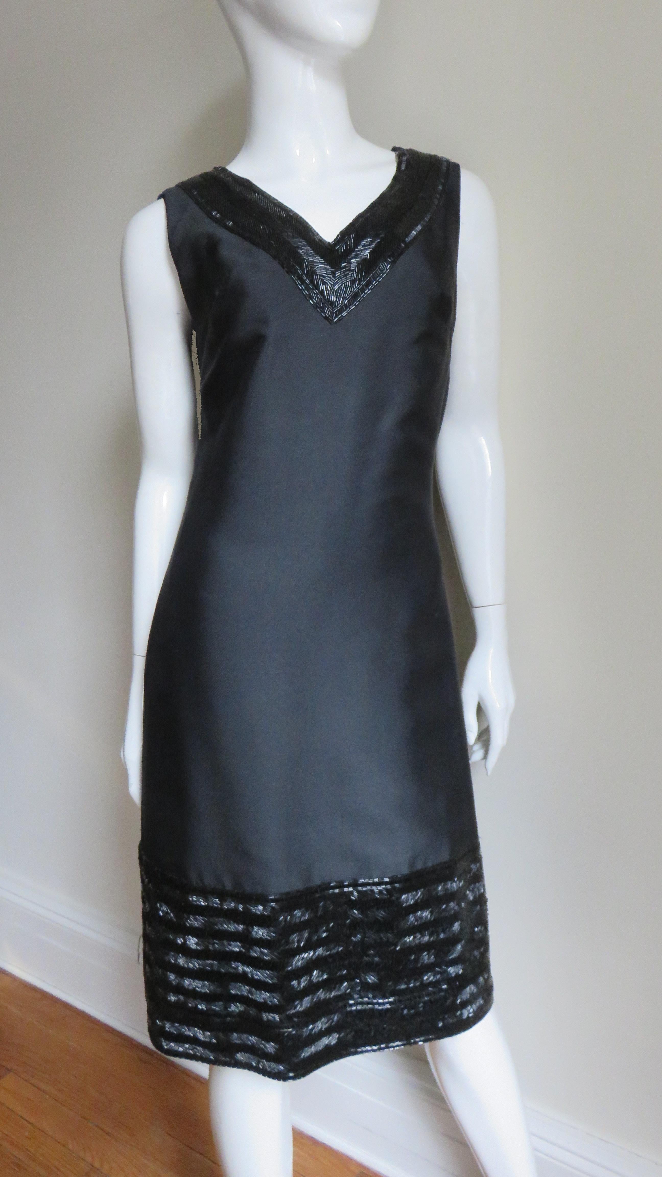 A gorgeous black silk dress with elaborate beaded trim from Raymond Martier, New York.  It has a V neckline, skims the body then falls straight to hem.  Around the neck 3.5