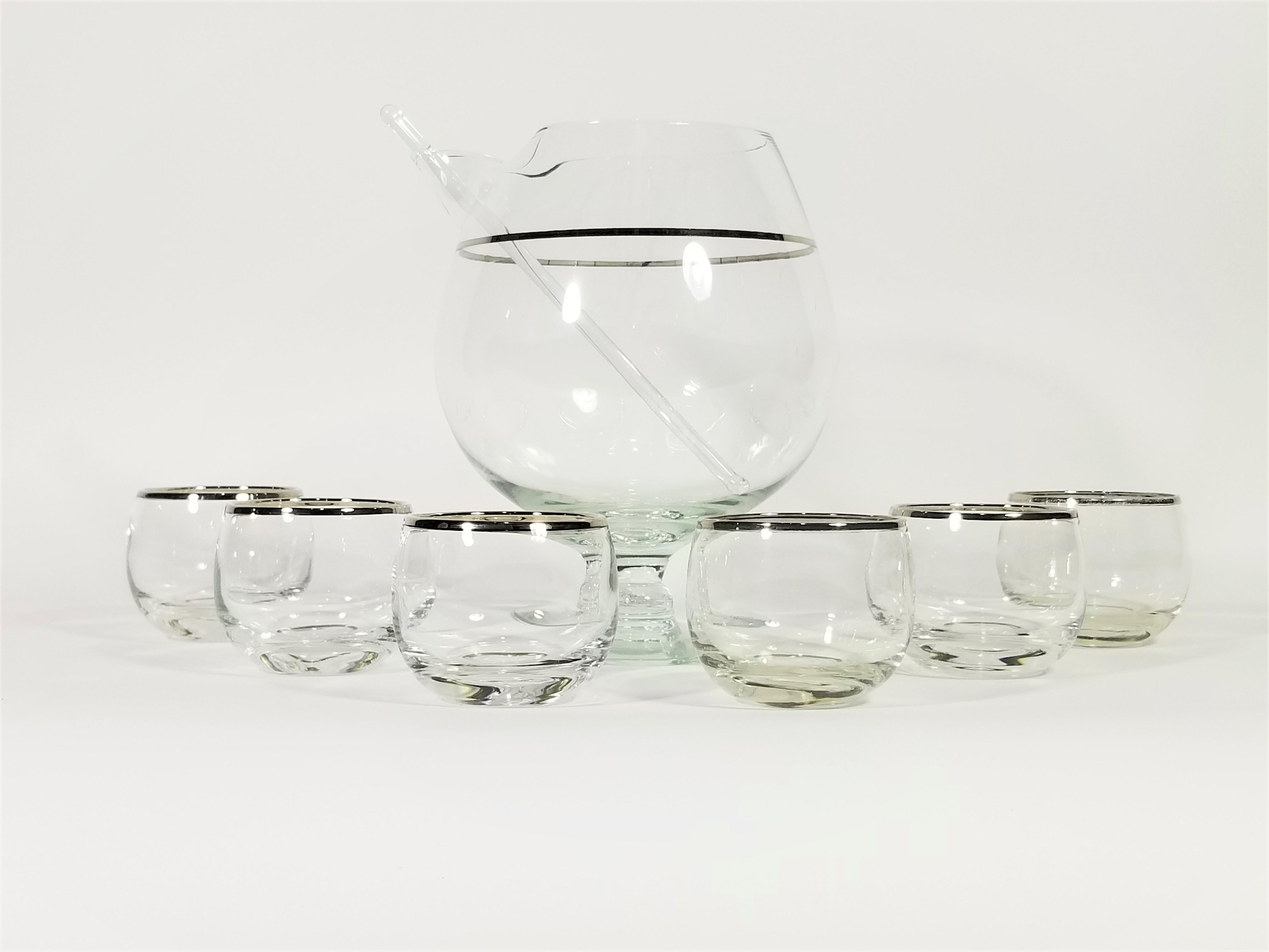 1960s Mid Century Modern Martini Set. Silver rimmed Glassware Barware in the style of Dorothy Thorpe. Pitcher with stirrer and six glasses. Glasses are often referred to as roly poly glasses due to their round modern shape. 


Martini Pitcher