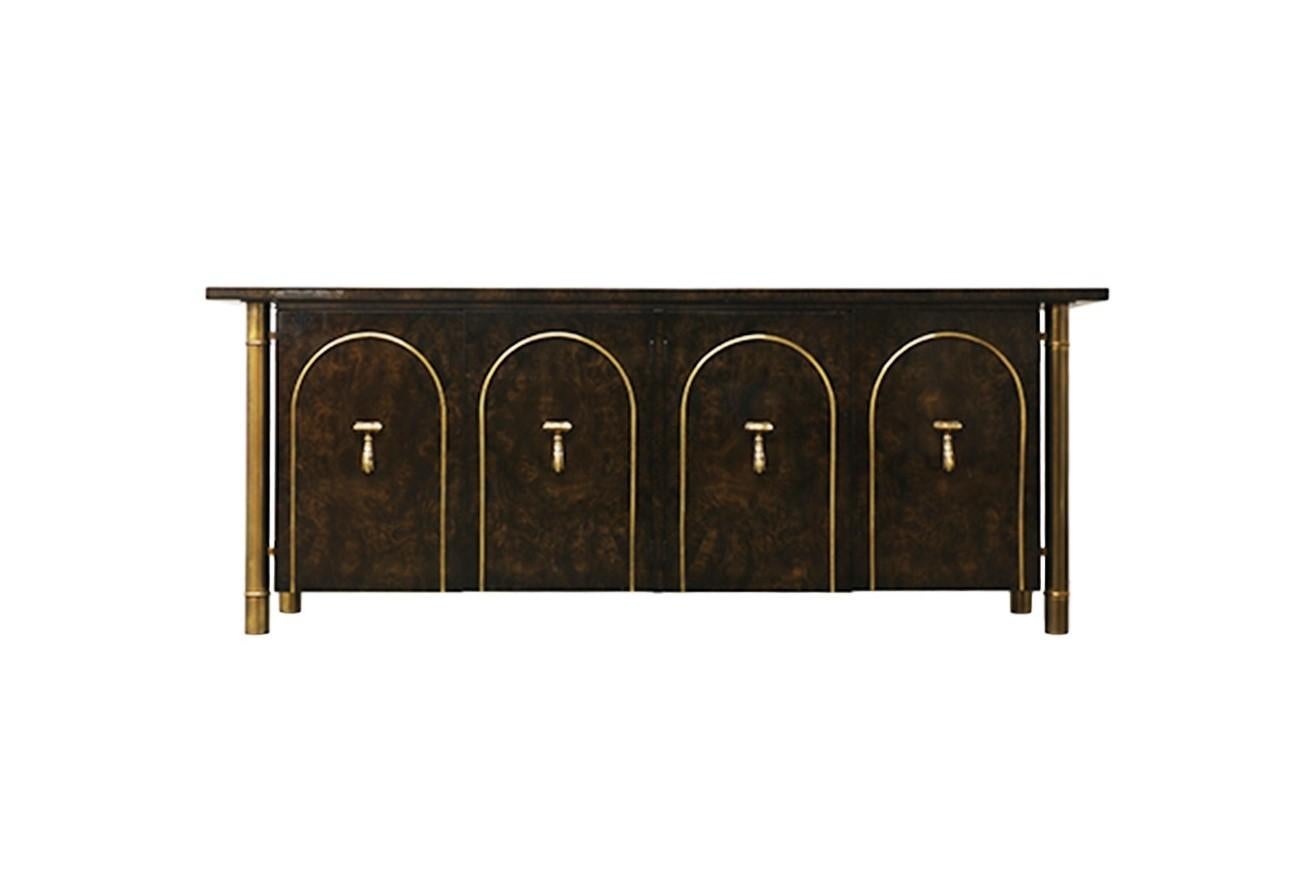 Breathtaking burl wood and brass Mastercraft sideboard/credenza, circa 1960. Four tubular outer skeletal brass support legs create a floating effect. The columns are fashioned in the style of bamboo stalks to add an Eastern flare. There are two sets