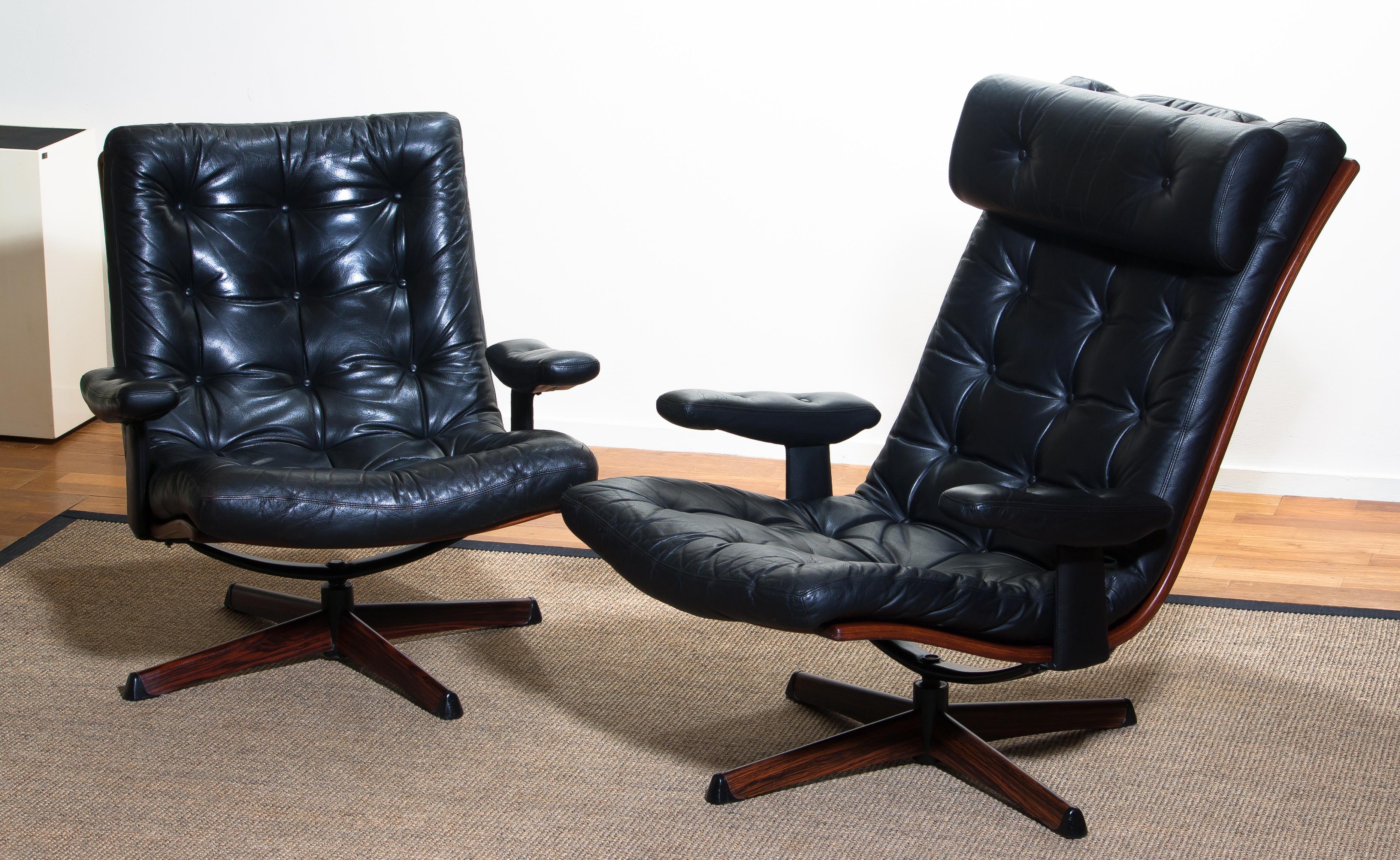 Beautiful set of two extremely comfortable and matching swivel chairs by Gote Design Nassjo Sweden, 1960
The metal swivel stands are covered with an Jakaranda print.
The chairs are upholstered with black sturdy leather and all in perfect