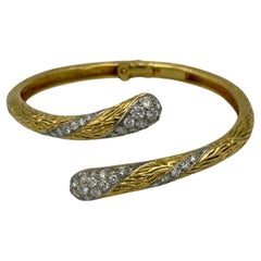 1960s Mauboussin 18k gold and diamond asymetric bangle 1960s Mauboussin 18k gold and diamond asymetric bangle
