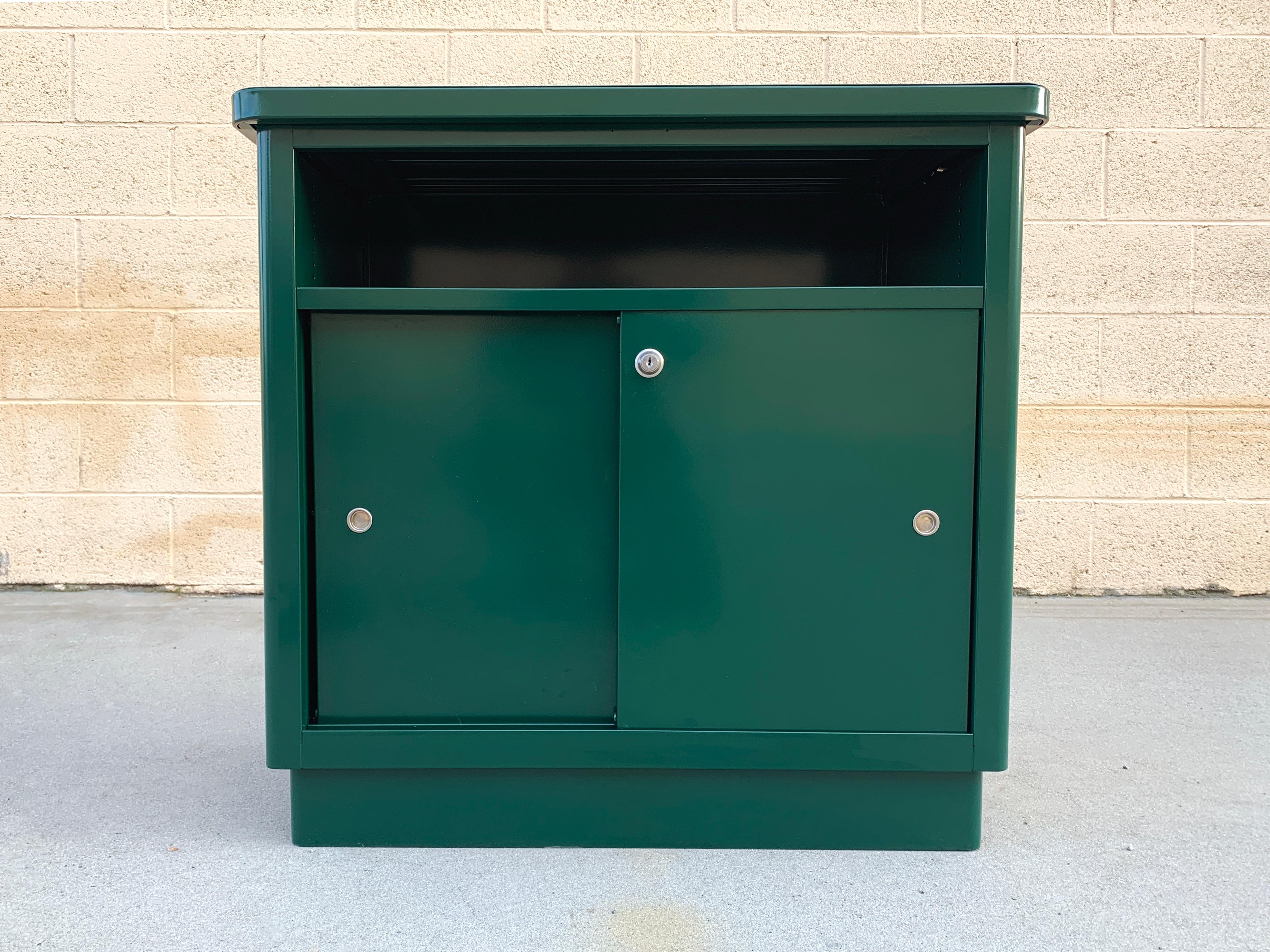 This old-school steel office cabinet by McDowell Craig has been completely transformed! We gave it a fresh powder coat finish in Forest Green (GN 03). Designed with 3 shelves and double sliding doors. Features a lock, but no key. 

Perfect as an