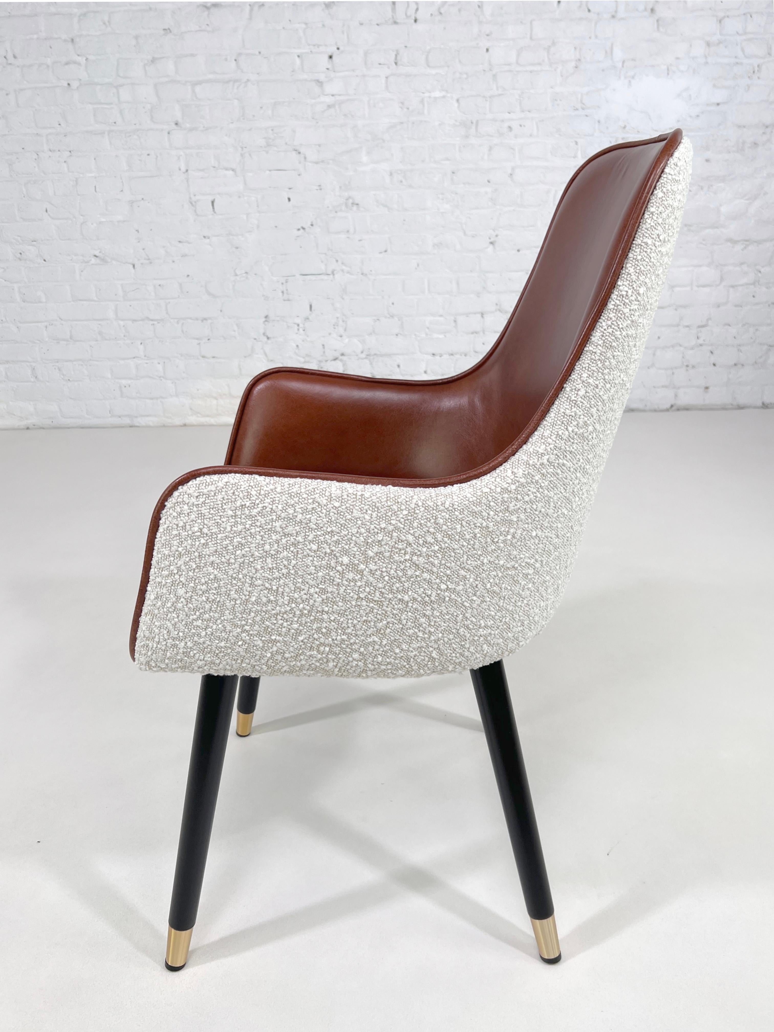 1950s - 1960s MCM Design Scandinavian Style Beige Bouclé Fabric With Cognac Leather Finishes Swivel Armchair composed of a black lacquered wooden feet brass finishes and a comfy seat in a cognac leather seat with beige bouclé fabric back.