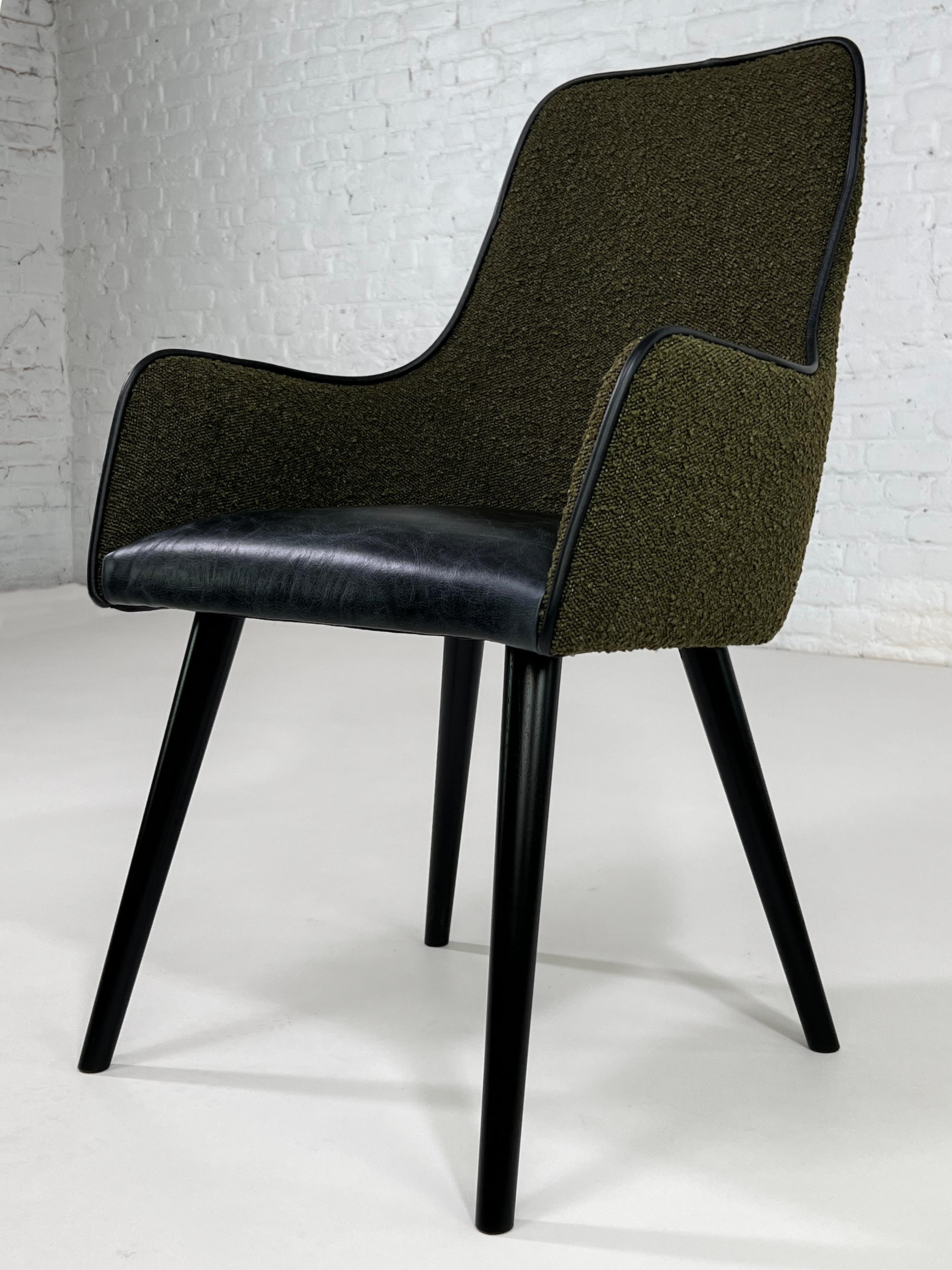 1950s - 1960s MCM Design Scandinavian Style Dark Green Bouclé Fabric With Patina Black Leather Finishes Chair composed of a black lacquered wooden feet and a comfy seat in a black leather seat with dark green bouclé fabric back.