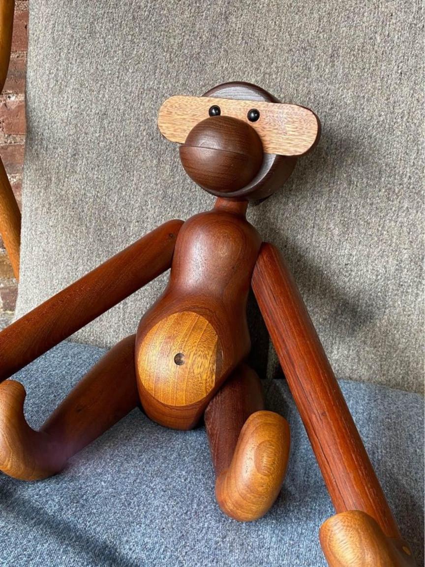 The rare, larger version of the 1960s Teak Ape Monkey by Kay Bojesen is a true treasure for collectors and enthusiasts alike. This extraordinary wooden figurine represents the epitome of Danish design from the mid-20th century. Meticulously
