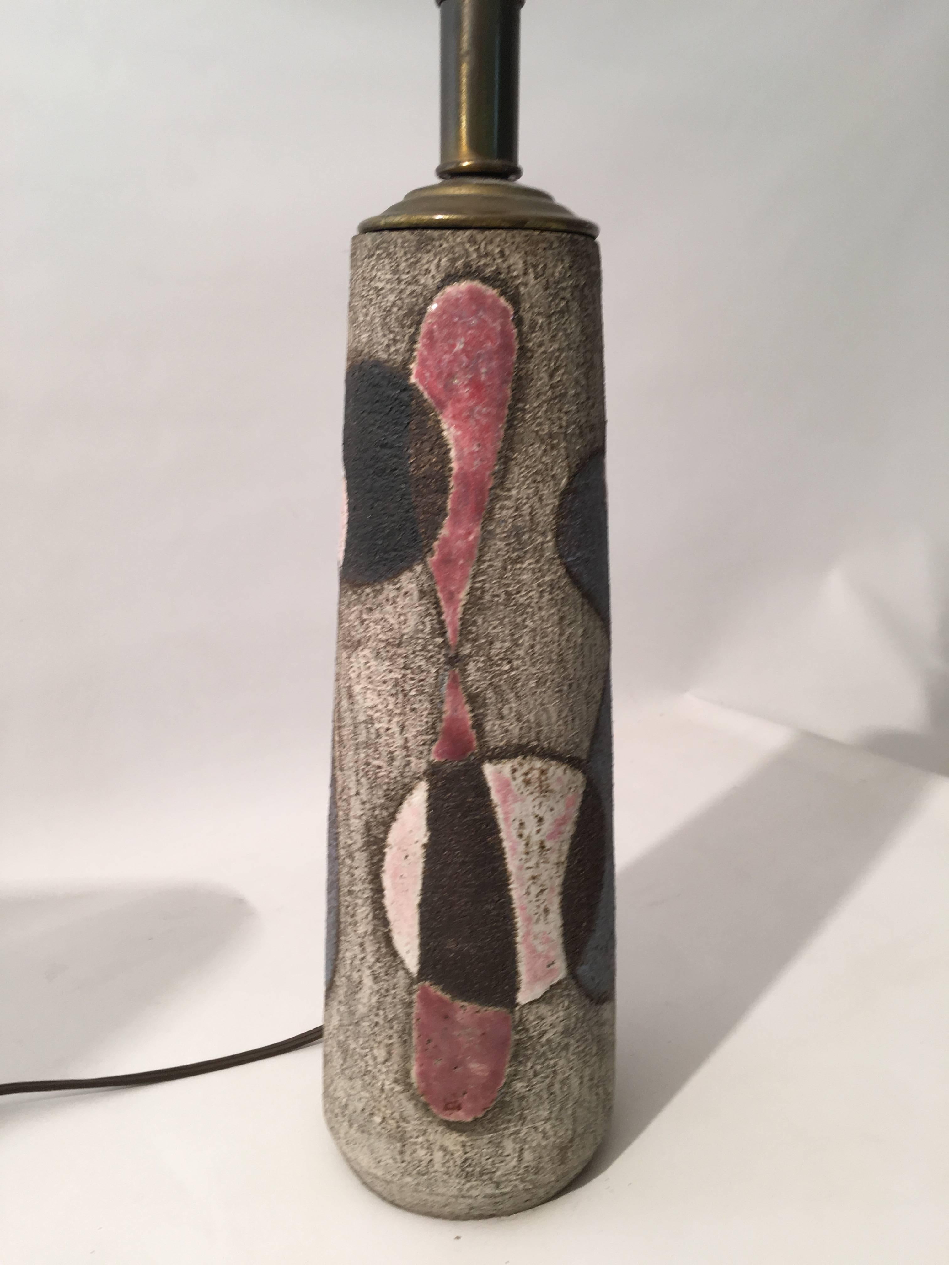 Beautiful abstract pattern pottery table lamp by Meidert Zaalberg. Dutch pottery that contrasted rough and smooth high glazed areas of color. The abstracted patterns of loops and circles are glazed in blue, red, black and white, circa 1960. The