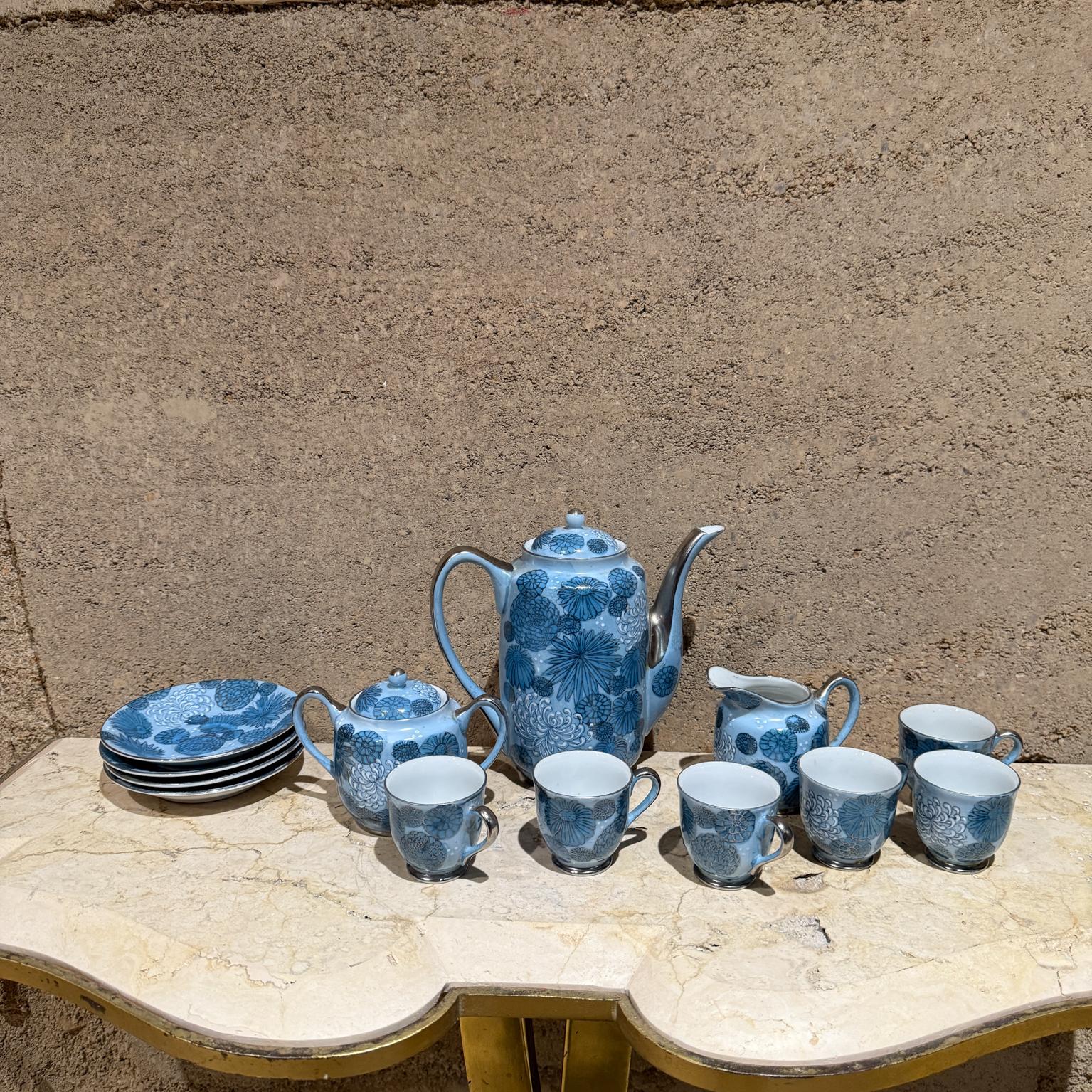 Meito Japan Blue Floral Porcelain Tea Set
Service for four plus extra 2 cups
made Japan
Teapot Creamer and Sugar Bowl
cups and saucers
Tea pot 6.75 x 4 w x 7.25
Sugar 3.75 h x 5 w x 3 d
Creamer 3.25 h x 2 w x 4 d
Plate 1 x 4.75 diameter (4)
Cups 2 h