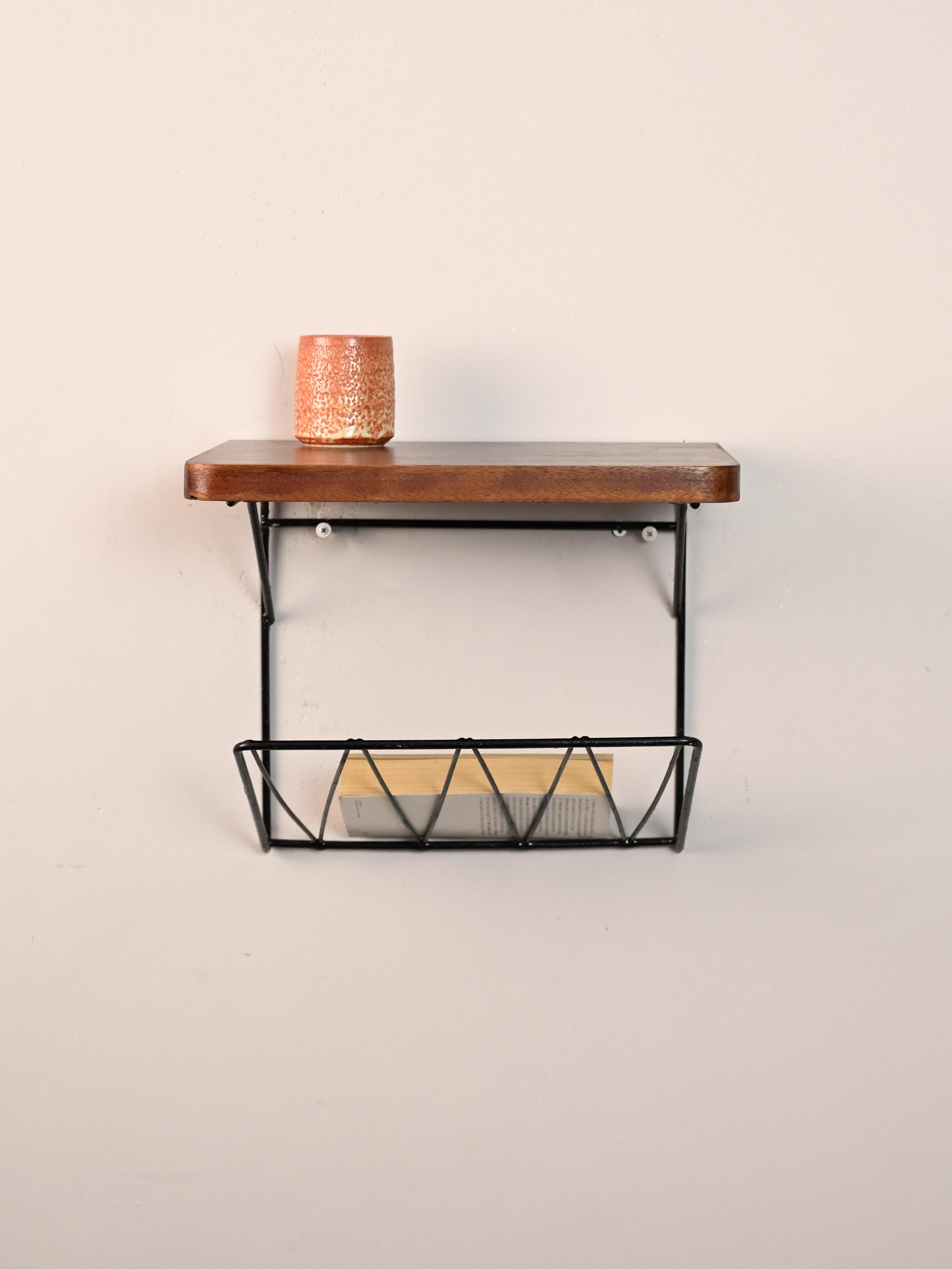Skandinavischer originaler Vintage-Nachttisch zum Aufhängen.

Kleines skandinavisches Möbelstück, das als Telefonständer verwendet wird.
Besteht aus einem einfachen Holzregal mit abgerundeten Ecken und einem schwarzen Zeitschriftenständer aus