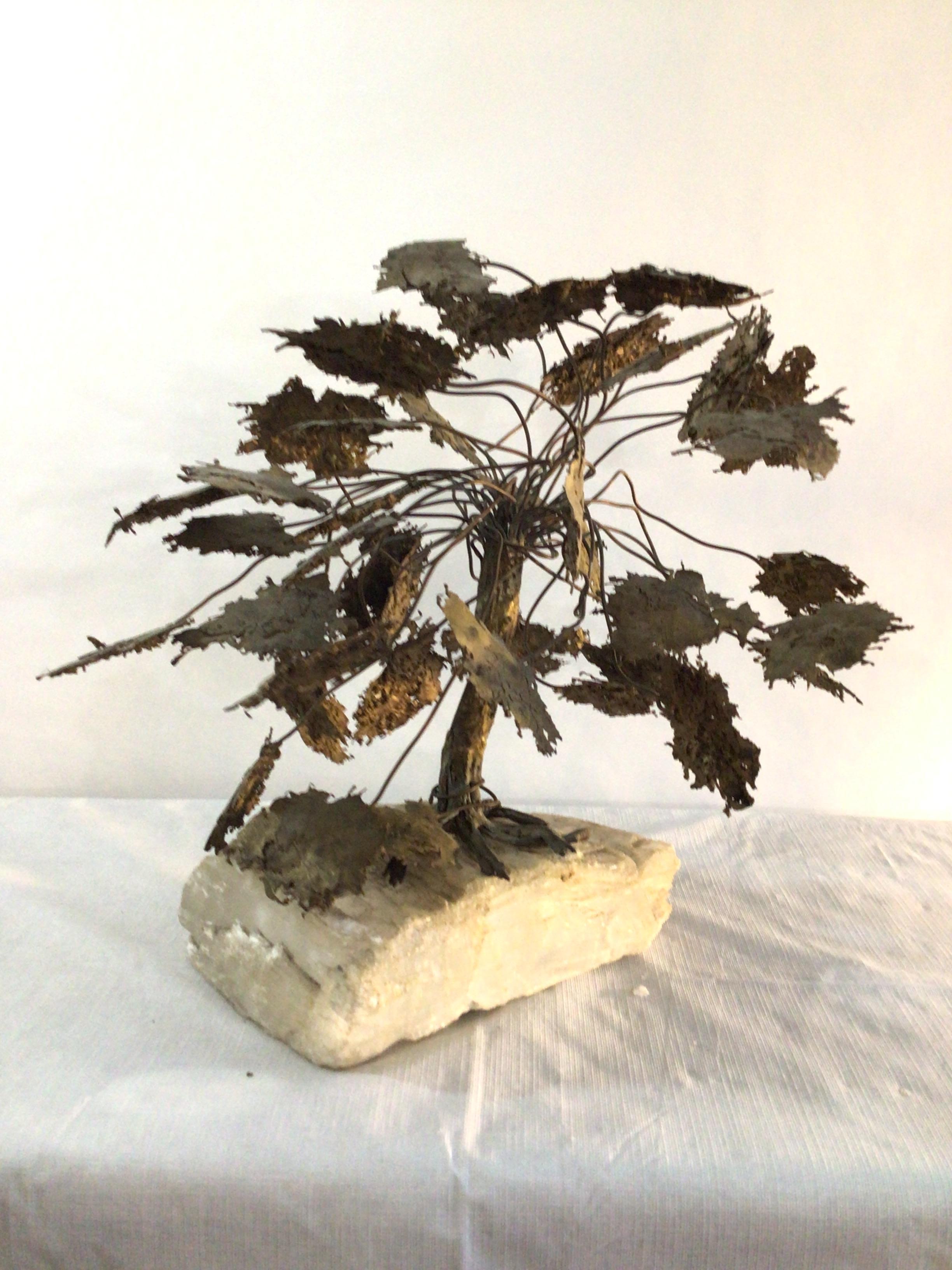 1960s Metal Tree Sculpture On Quartz Stone Base
Beautiful piece of sculpture in the form of a large tree with leaves atop a free form rock crystal base
The leaves have etched details on both the top and bottom and there is a center trunk which