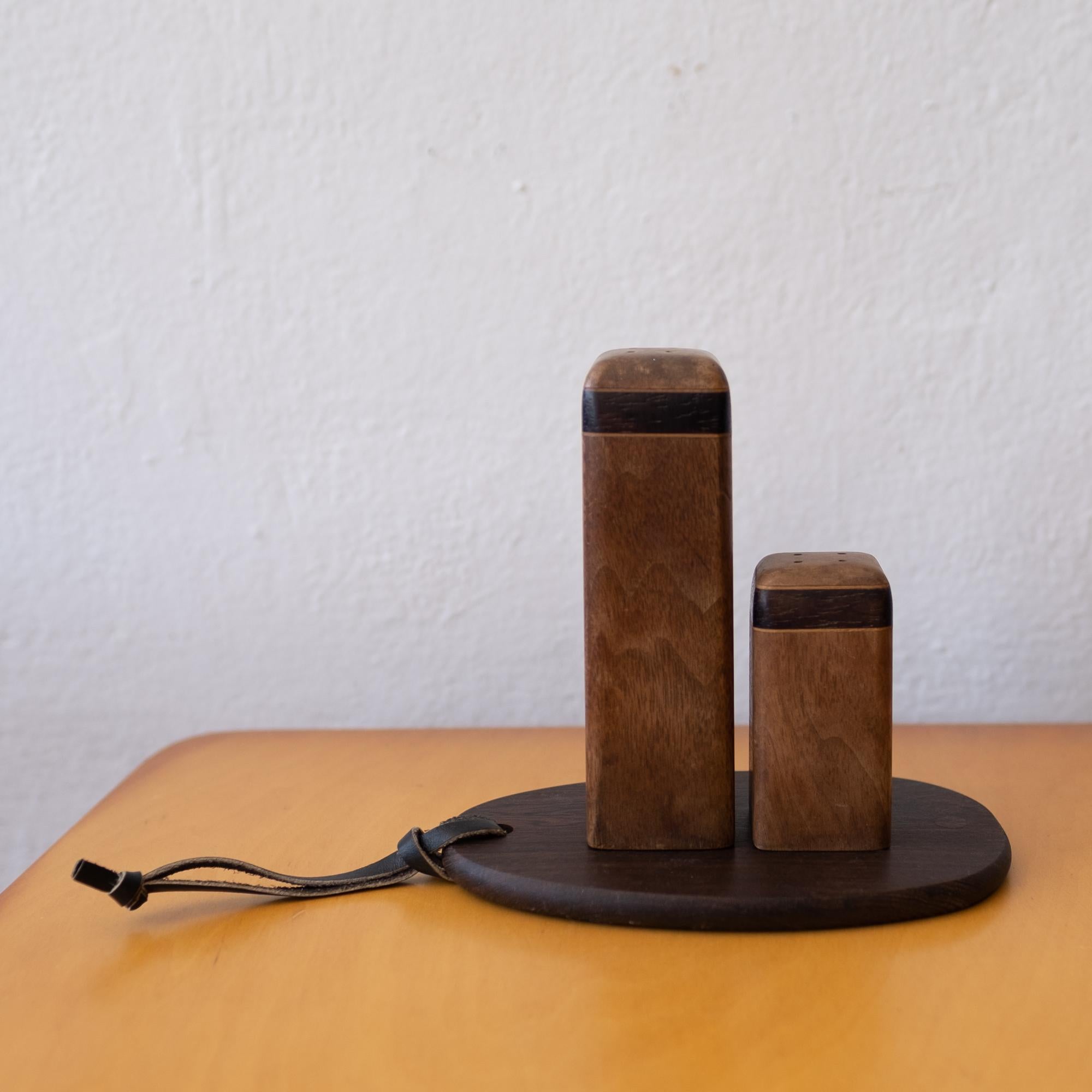 A salt and pepper set with tray by Don Shoemaker. Constructed of mixed woods, including cocobolo and oak. Produced is his studio in Senal, Mexico. The tray is stamped Mexico, 1960s.