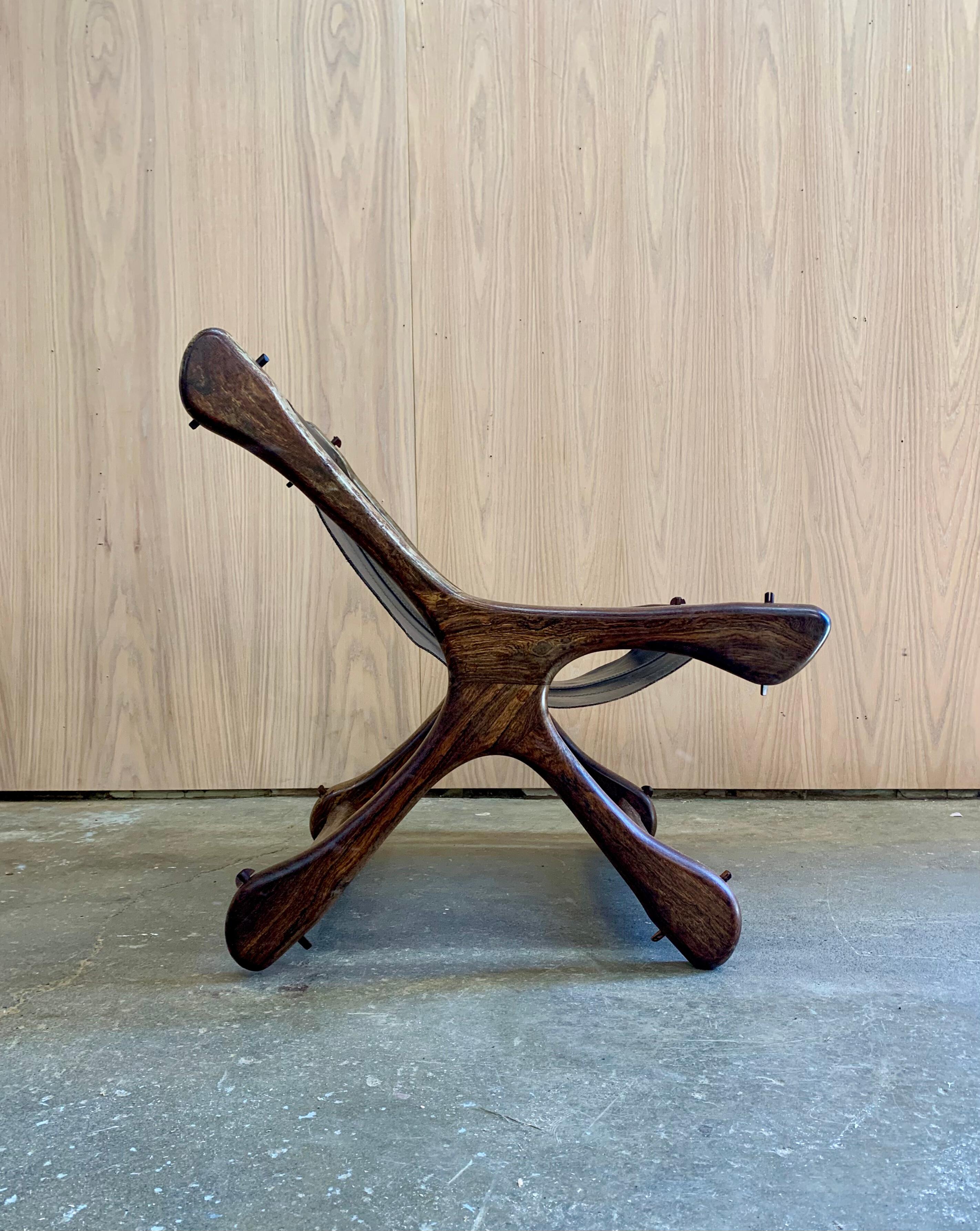 Icono escultural del modernismo mexicano de los años 60, este sillón de Don Shoemaker para Señal S.A. muestra las líneas orgánicas y la maestría artesanal características del diseñador. Tallado en madera maciza de cocobolo, el marco presenta curvas