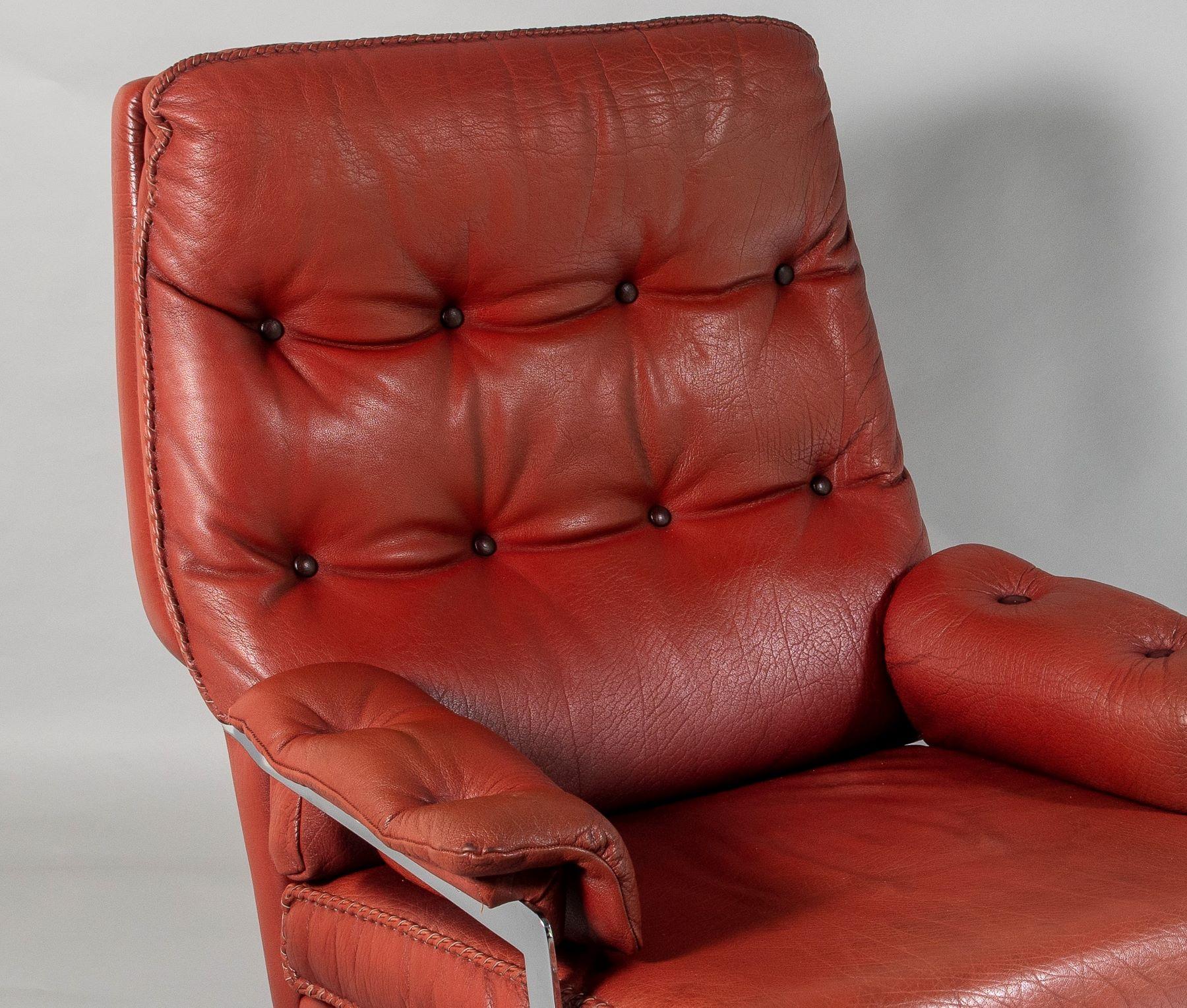 A beautifully made 1960s leather swivel chair. A well crafted piece with heavy chrome base and high quality leather with hand stitching. Originally a dark reddish brown, the leather has faded to this wonderful, almost burnt orange colour which gives