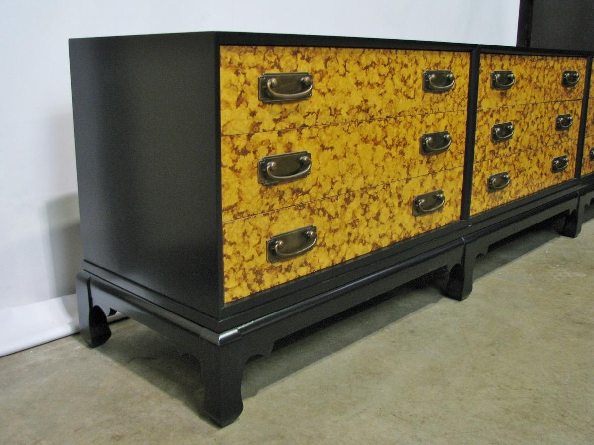 Extraordinary 1960s four-part console or credenza. Unmarked, but of a excellent quality equivalent to Baker or Henredon. An Asian-inspired base holds three identical chests, each with three drawers. Satin black base and cases have all been