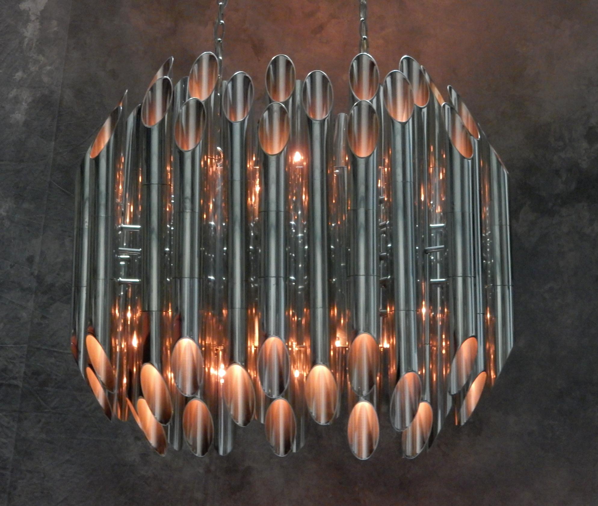 Truly remarkable vintage chandelier from the 1960's.
Requires 72 individual dimmable S11 bulbs(included). 36 facing up and 36 facing down. 
Each bulb is hidden behind an angular cut tube shade highly polished on both inside and out causing a