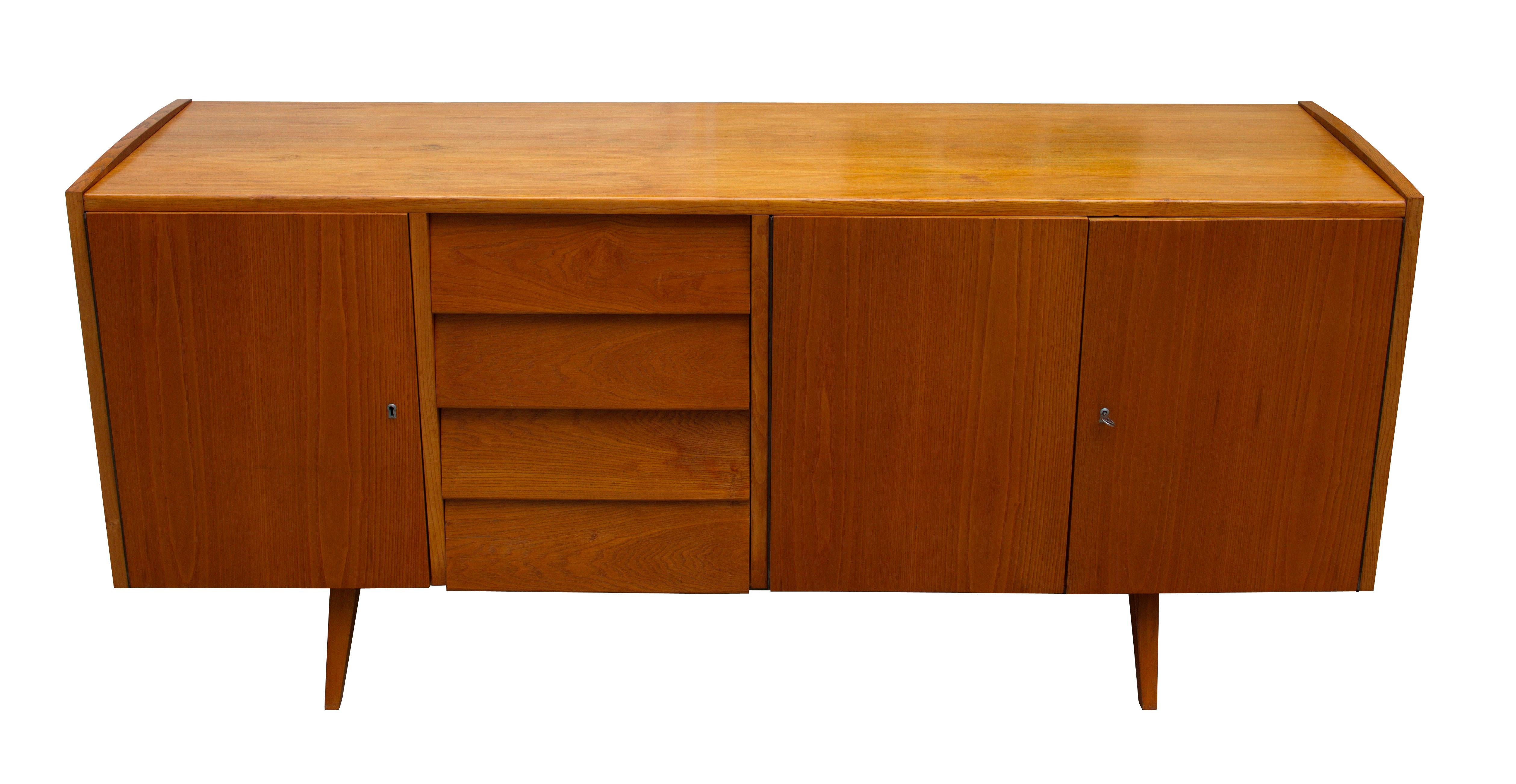 This midcentury sideboard was designed by the legendary Czech furniture designer Frantisek Jirak, and was manufactured in 1960s Czechoslovakia.
This piece is made of Ash and the charm of this sideboard lies in the elegant proportions and subtle