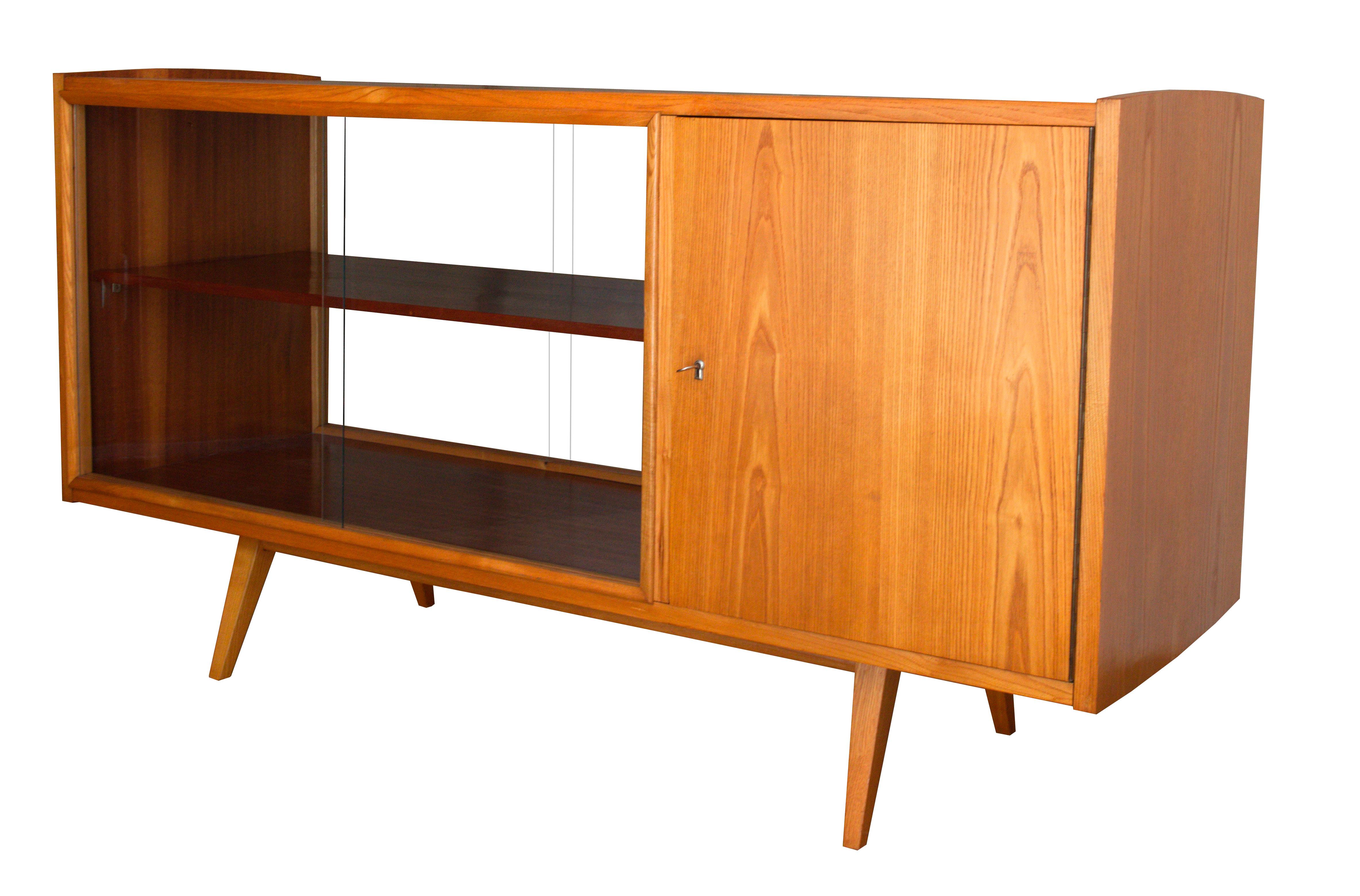 This midcentury sideboard was designed by the legendary Czech furniture designer Frantisek Jirak, and was manufactured in 1960s Czechoslovakia. This sideboard has got sliding glass doors on both sides and therefore offers more flexible options for