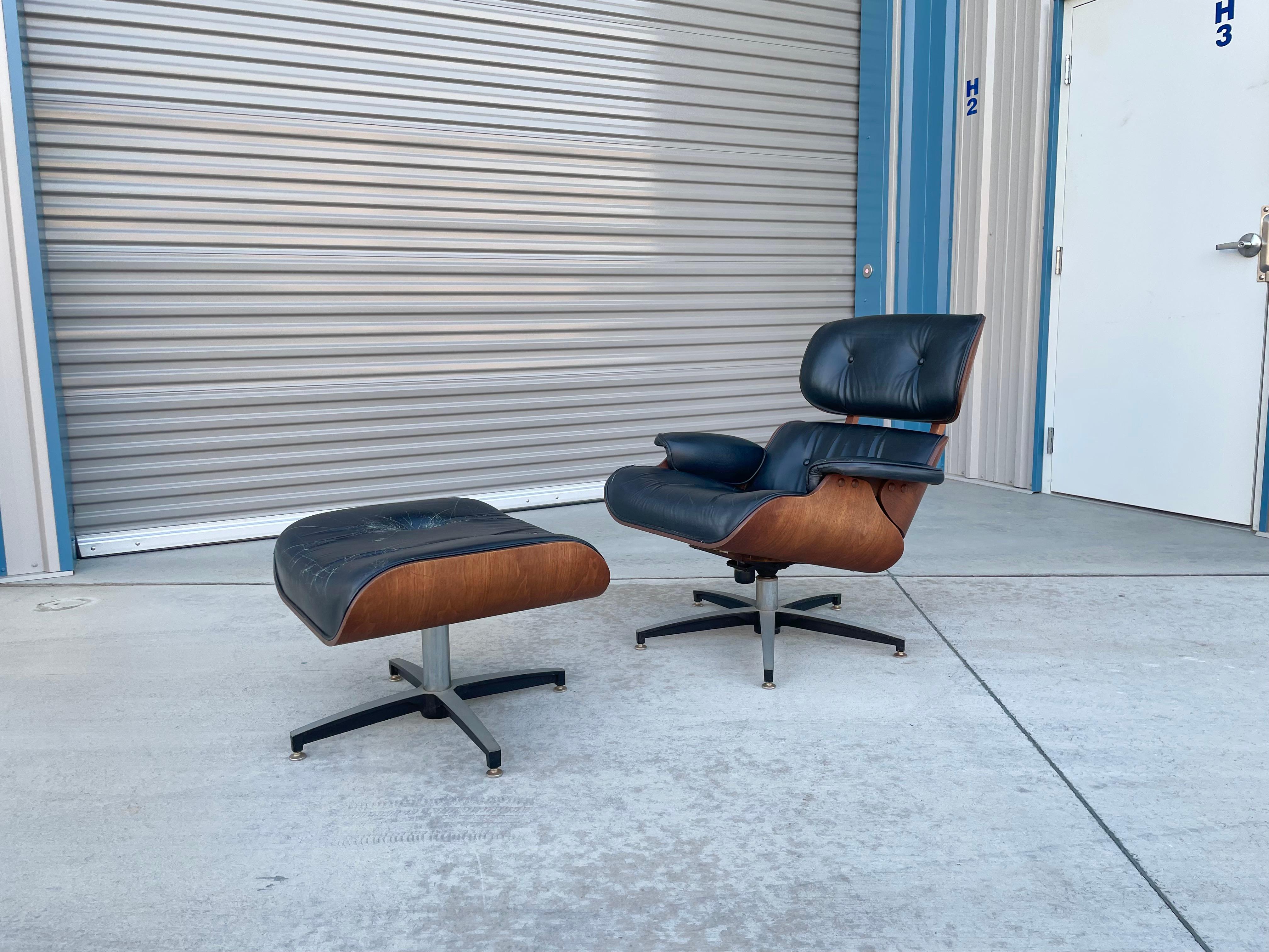 Mid-century chair and ottoman designed and manufactured in the United States circa 1960s. This beautiful chair and ottoman was styled after Herman Miller. This set features a walnut frame with a black leather upholstery, a classic piece that would