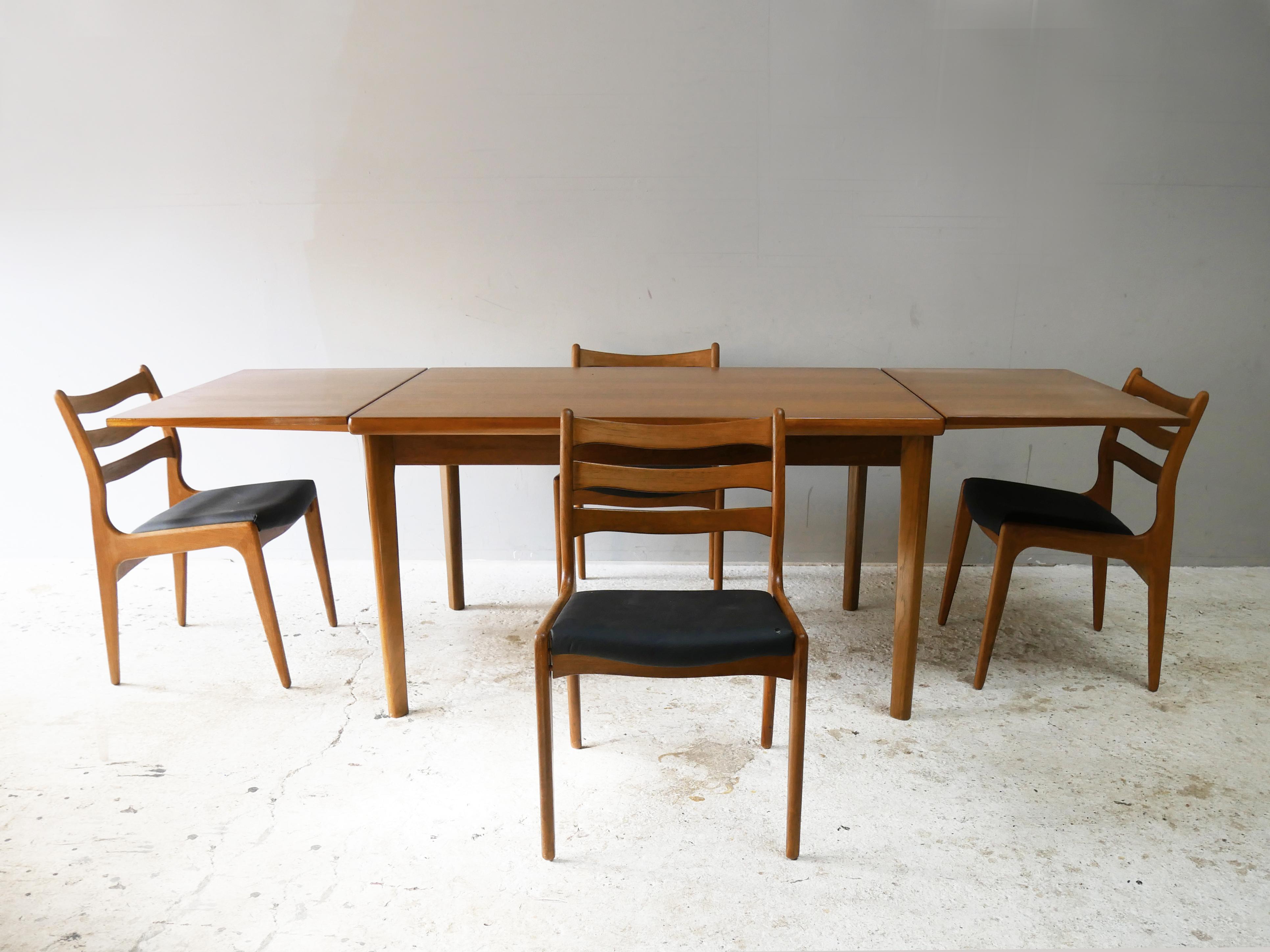 A large draw leaf dining table and 4 dining chairs produced by AM Mobler Ansager Møbler) in the 1960’s.

The depth of the table is still very slim even when unextended. Clever design allows the extension leaves to sit in a space under the table