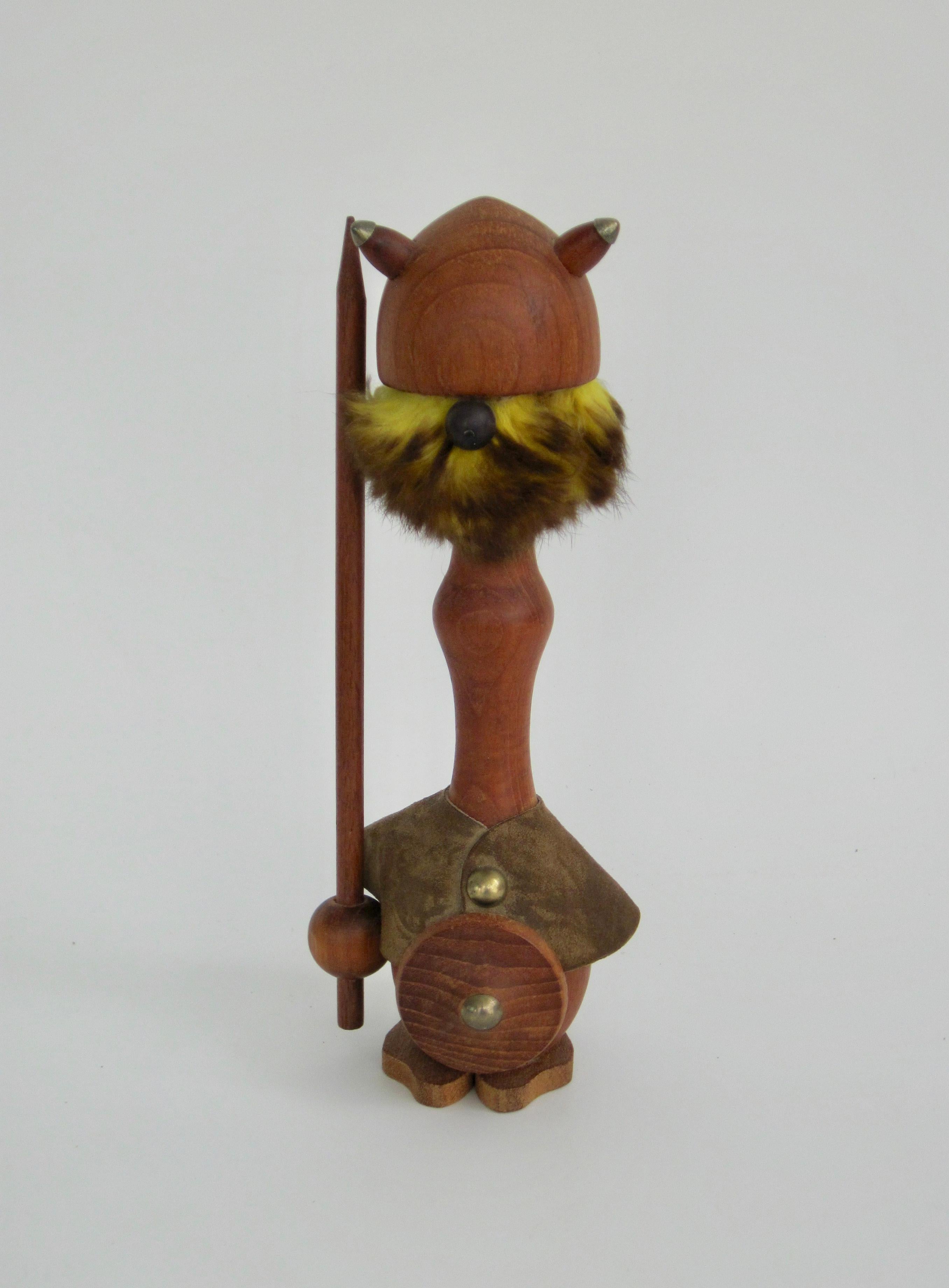 Sallingboe Denmark 1960s teak viking figurine with lance in one hand, a shield in the other. Adorned with a leather cape and horned helmet with brass details, a chartreuse fur beard and hair, he's ready for battle. Charming fella isn't he?