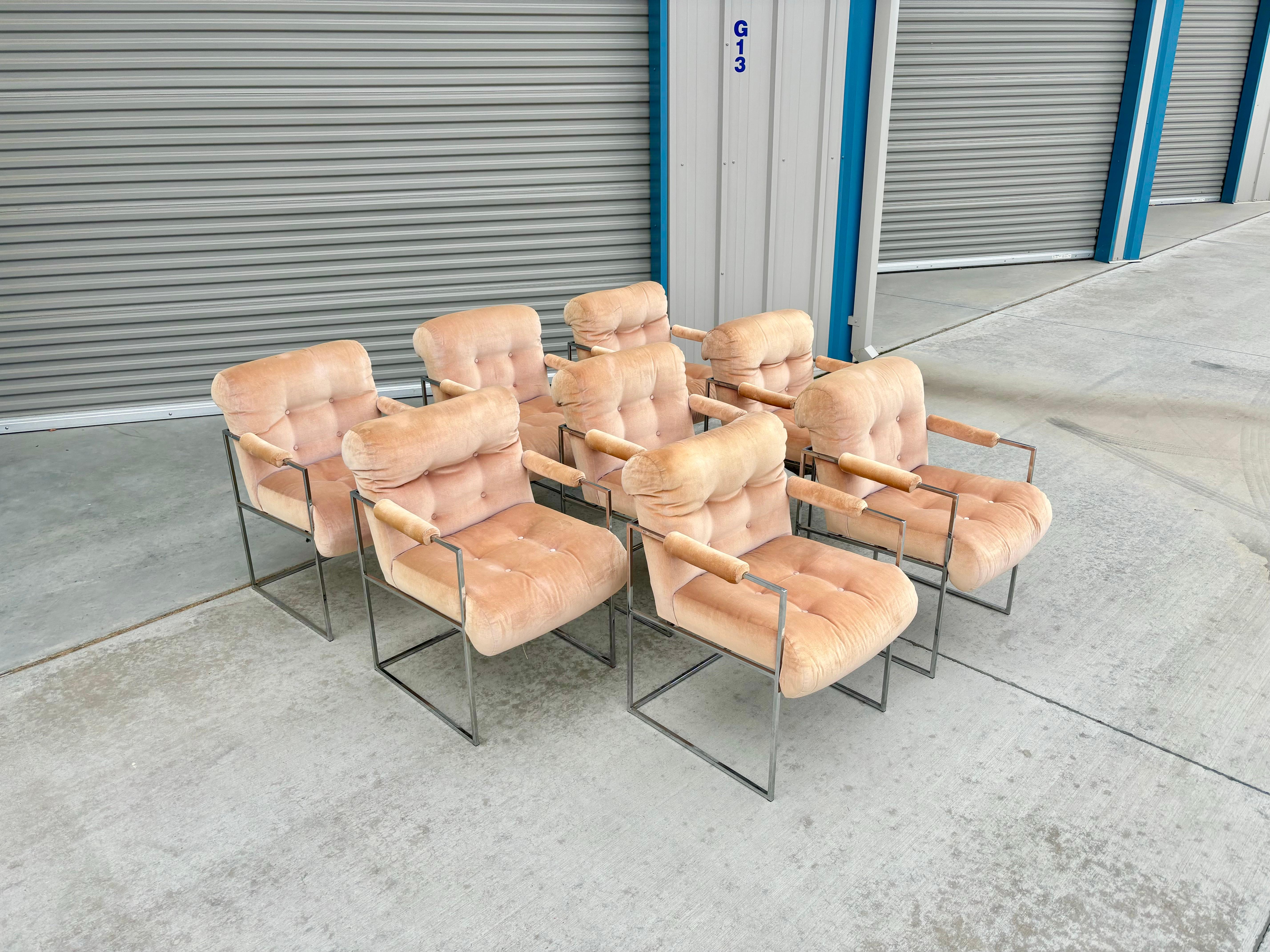 These stunning mid-century dining chairs were designed by Milo Baughman and manufactured by Thayer Coggin in the United States during the 1960s. This set includes eight chairs, each featuring a sleek chrome frame and comfortable armrests. The chairs