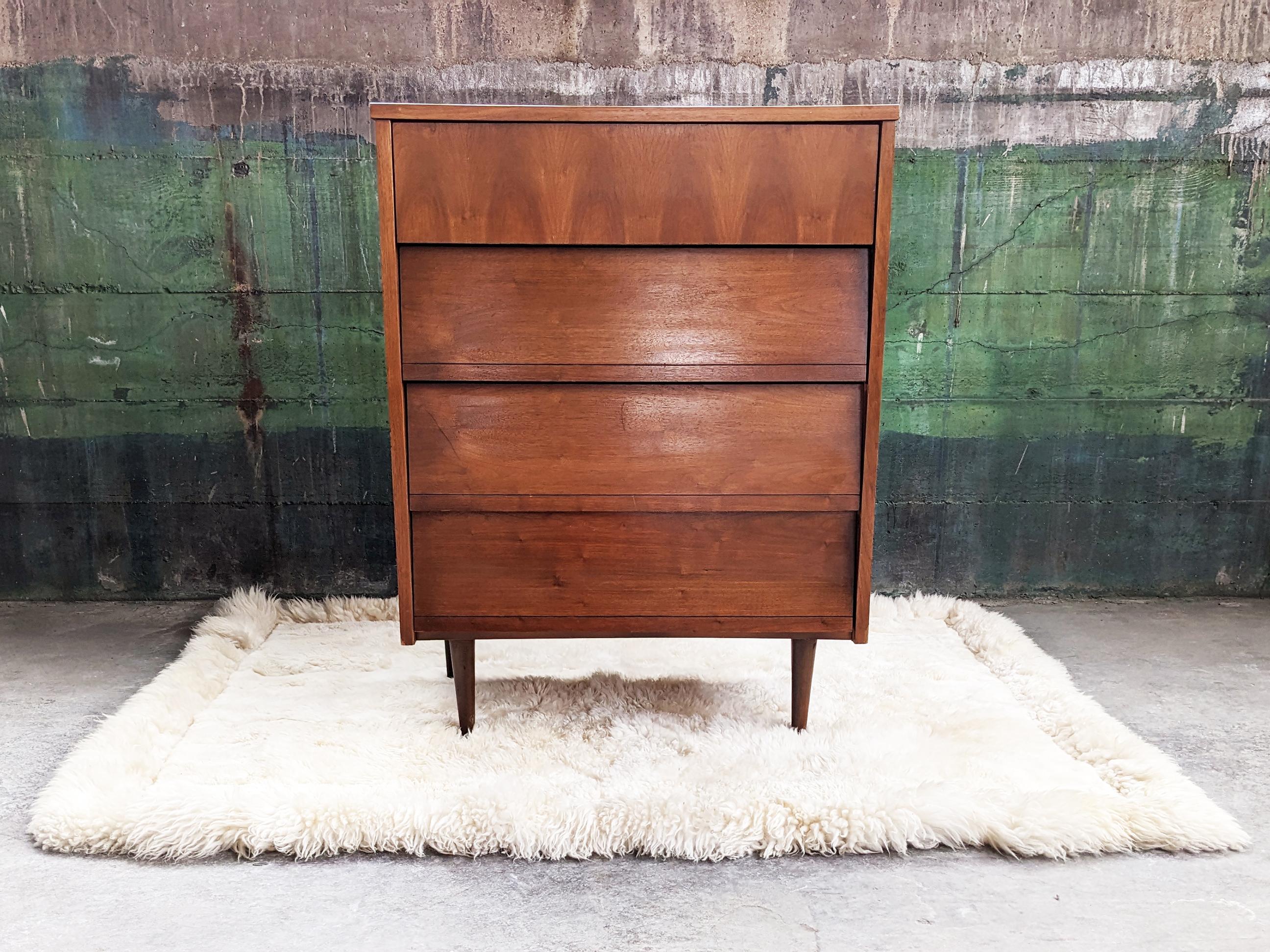 This beautiful dresser is perfect for a city apartment or bedroom-- great to be used as in any room for storage-- clothing, bar in a kitchen, entry way, the uses are endless. Gorgeous mid-century dresser featuring a solid wood frame with walnut