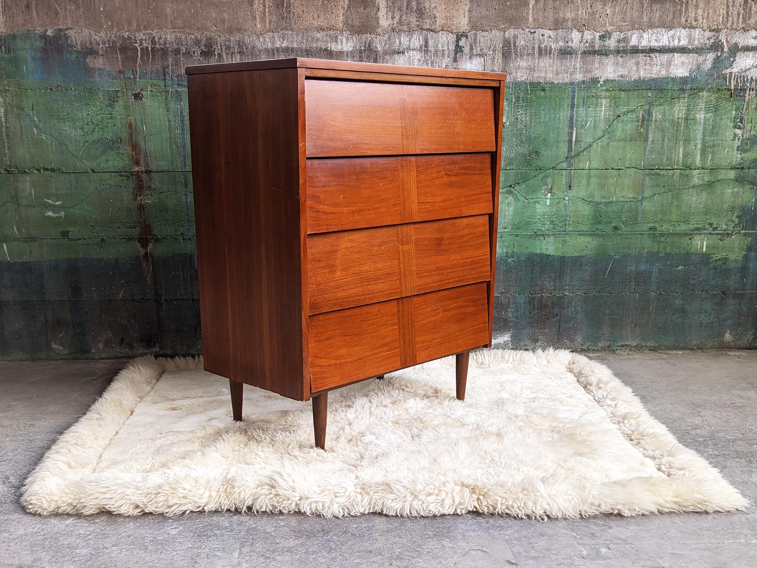This beautiful dresser is perfect for a city apartment or bedroom-- great to be used as in any room for storage-- clothing, bar in a kitchen, entry way, the uses are endless. Gorgeous mid-century dresser featuring a solid wood frame with walnut