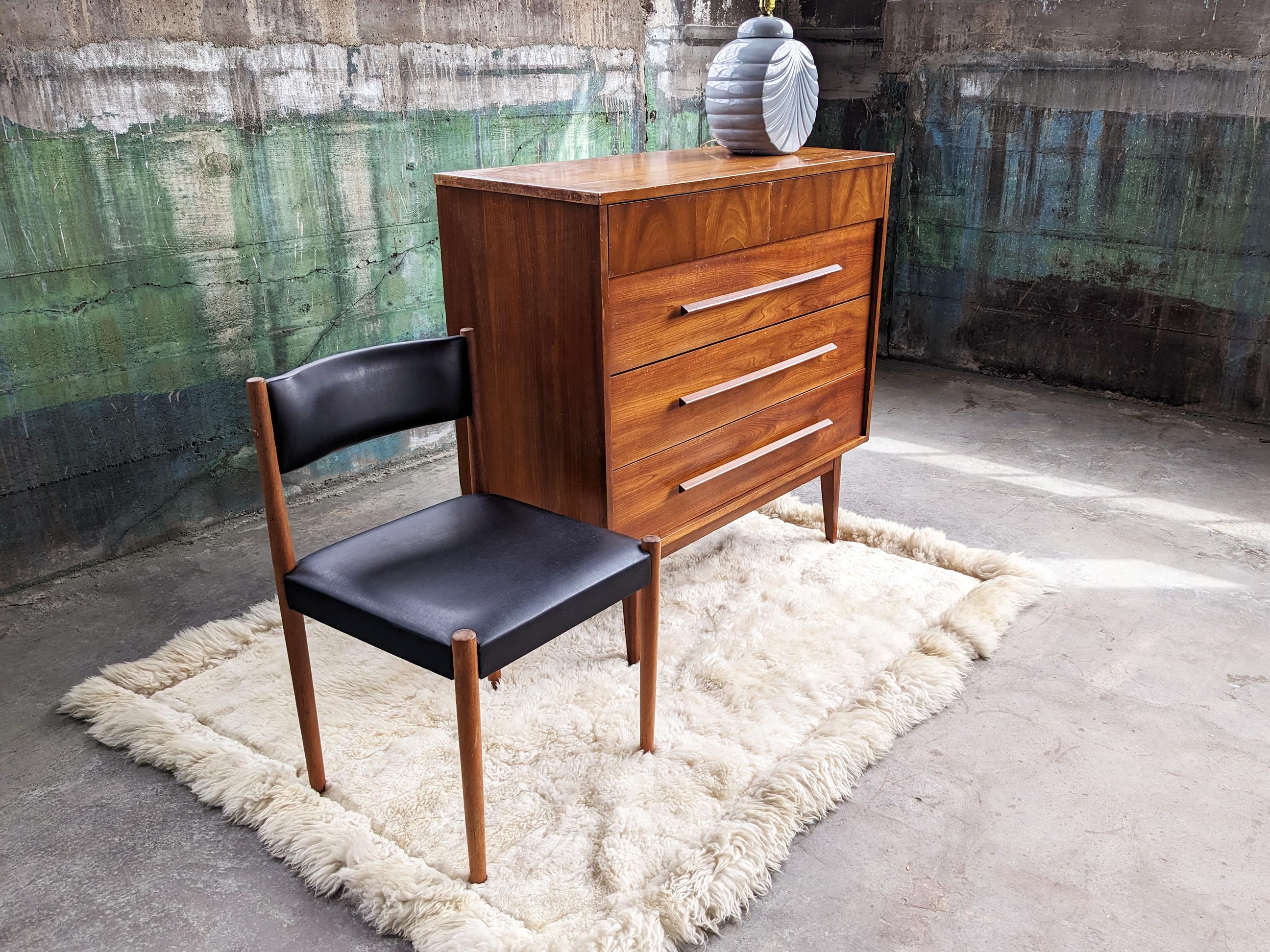 This beautiful dresser is perfect for a city apartment or bedroom-- great to be used as in any room for storage-- clothing, bar in a kitchen, entry way, the uses are endless. Gorgeous mid-century dresser featuring a solid wood frame with teak