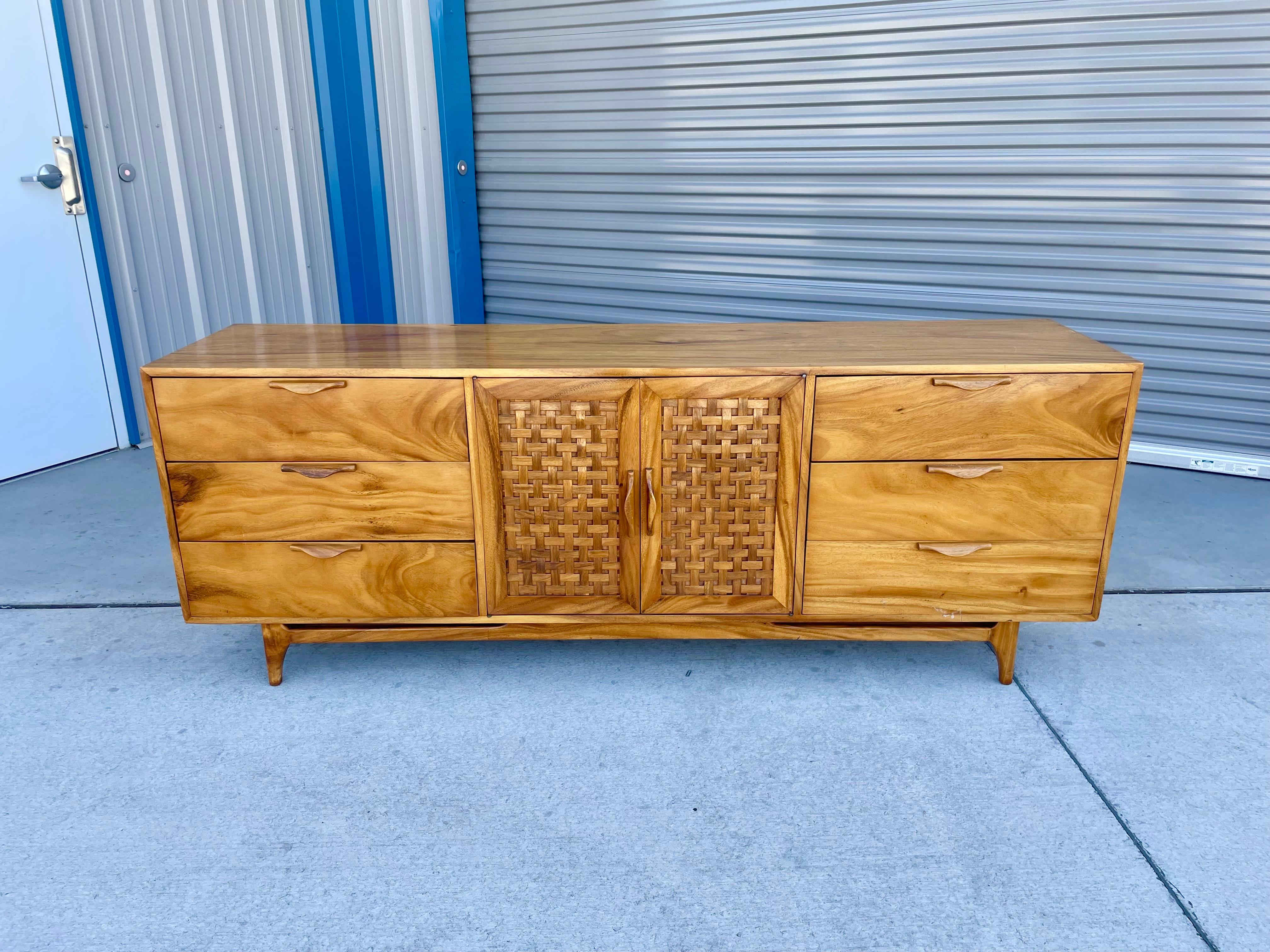Mid-century modern walnut credenza designed and manufactured in the United States circa 1960s. This stunning credenza was styled after lane furniture. This credenza is gorgeous, with its beautiful walnut frame that will add a touch of sophistication