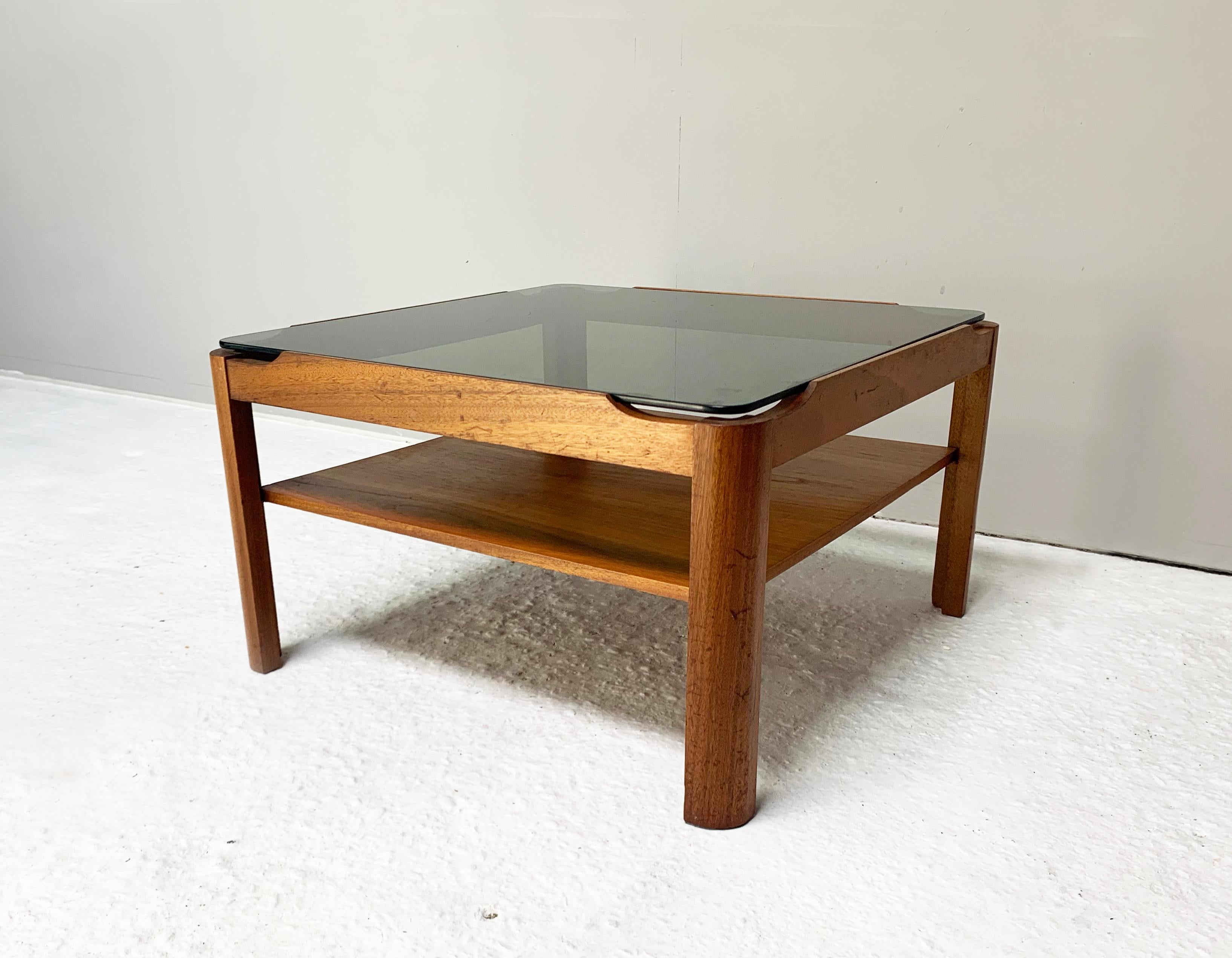 Mid-Century Modern coffee table by respected English maker ‘Myer’. Solid countered teak frame with thick smoked glass insert

Size 
width 61cm x depth 61m x height 35cm

Condition:
Very good mid century condition. Minor signs of wear