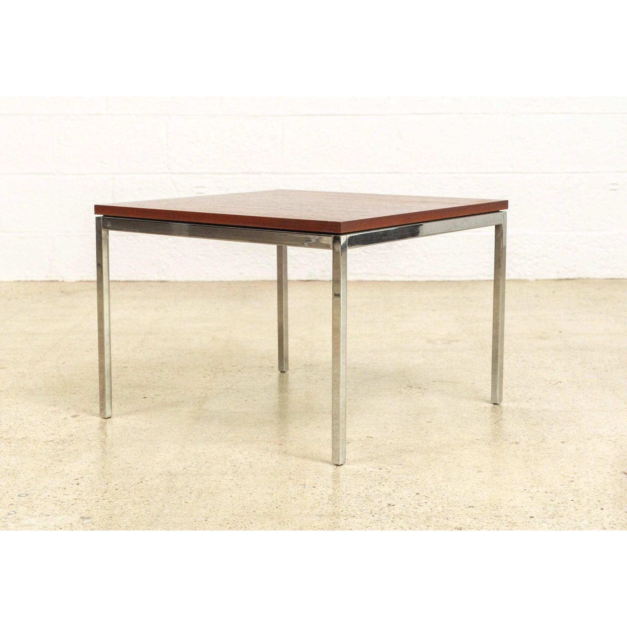 This vintage Mid-Century Modern Florence Knoll for Knoll Associates, Inc. square wood coffee table is circa 1960 and features a walnut wood top on a steel frame. This iconic table is a modern Classic and exemplifies the clean, Minimalist design of