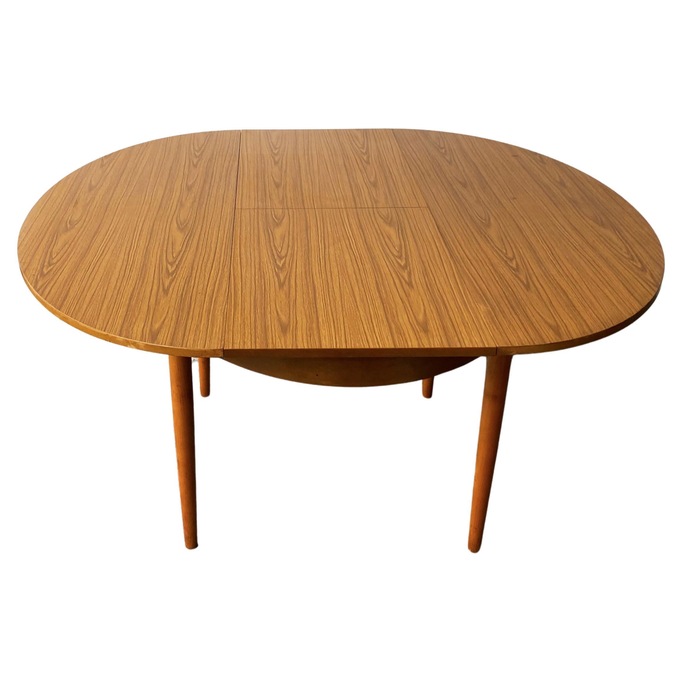 1960’s mid century Formica extending dining table by Schreiber For Sale