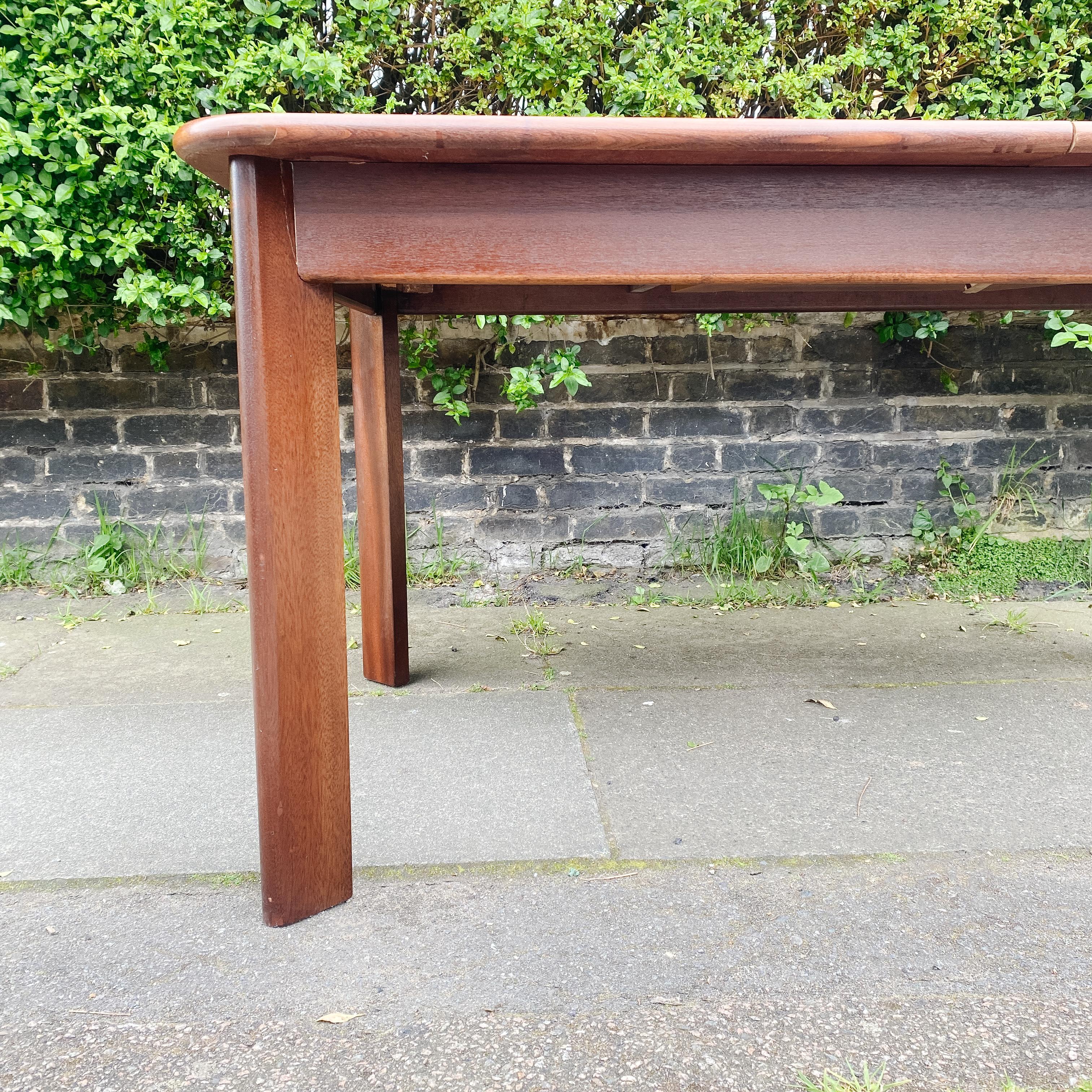 Step back in time with this iconic piece: a 1960s Mid Century G Plan Extending Dining Table with Angled Legs. Crafted with the sleek lines and timeless design characteristic of the mid-century era, this table exudes sophistication and style. Its
