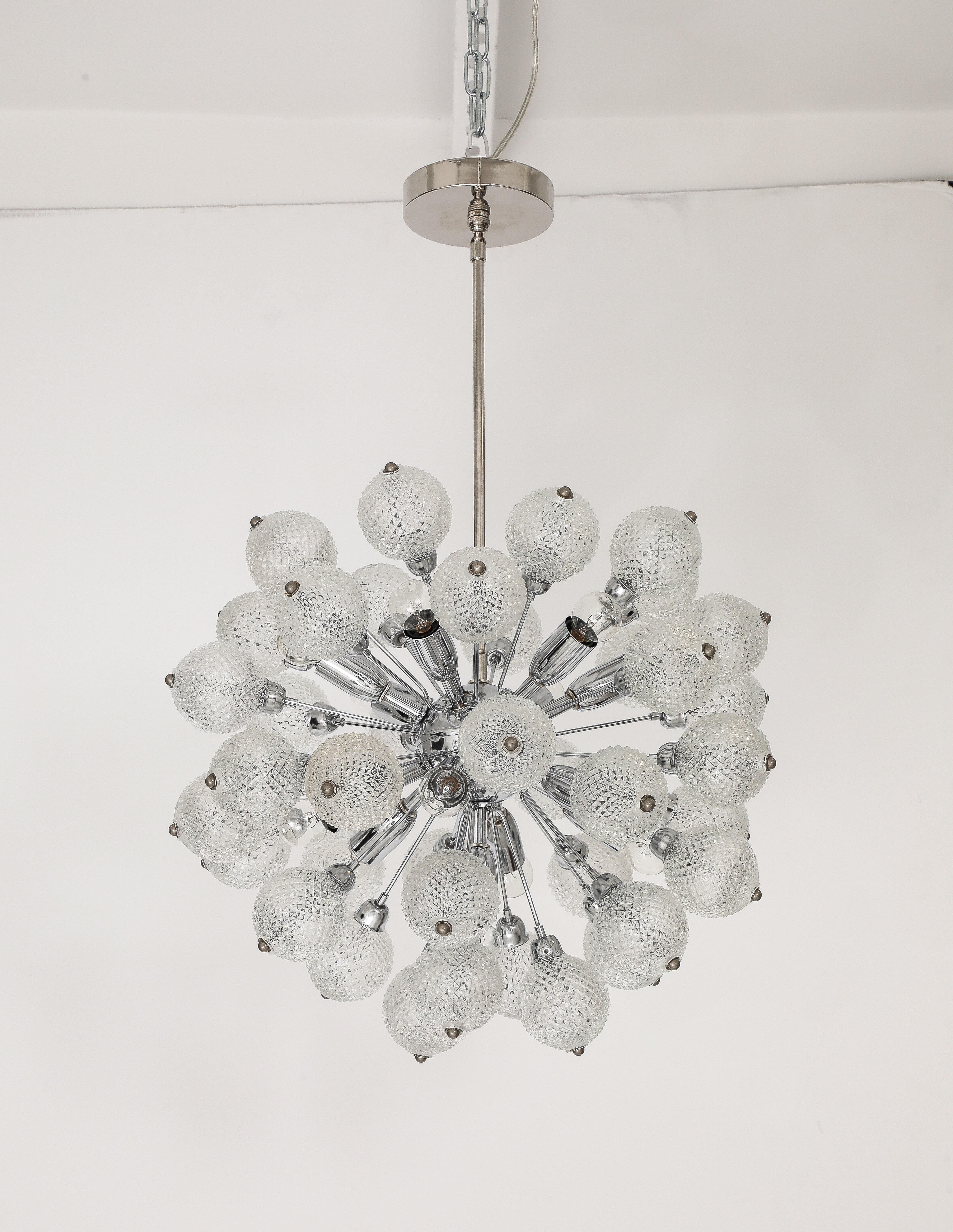 1960's  Mid - Century Modern Sputnik chandelier.
The polished chrome fixture supports 39 faceted glass ball elements that are grouped in  clusters of 3, and each cluster is illuminated with their own light source. 
The chandelier has 13 lights that