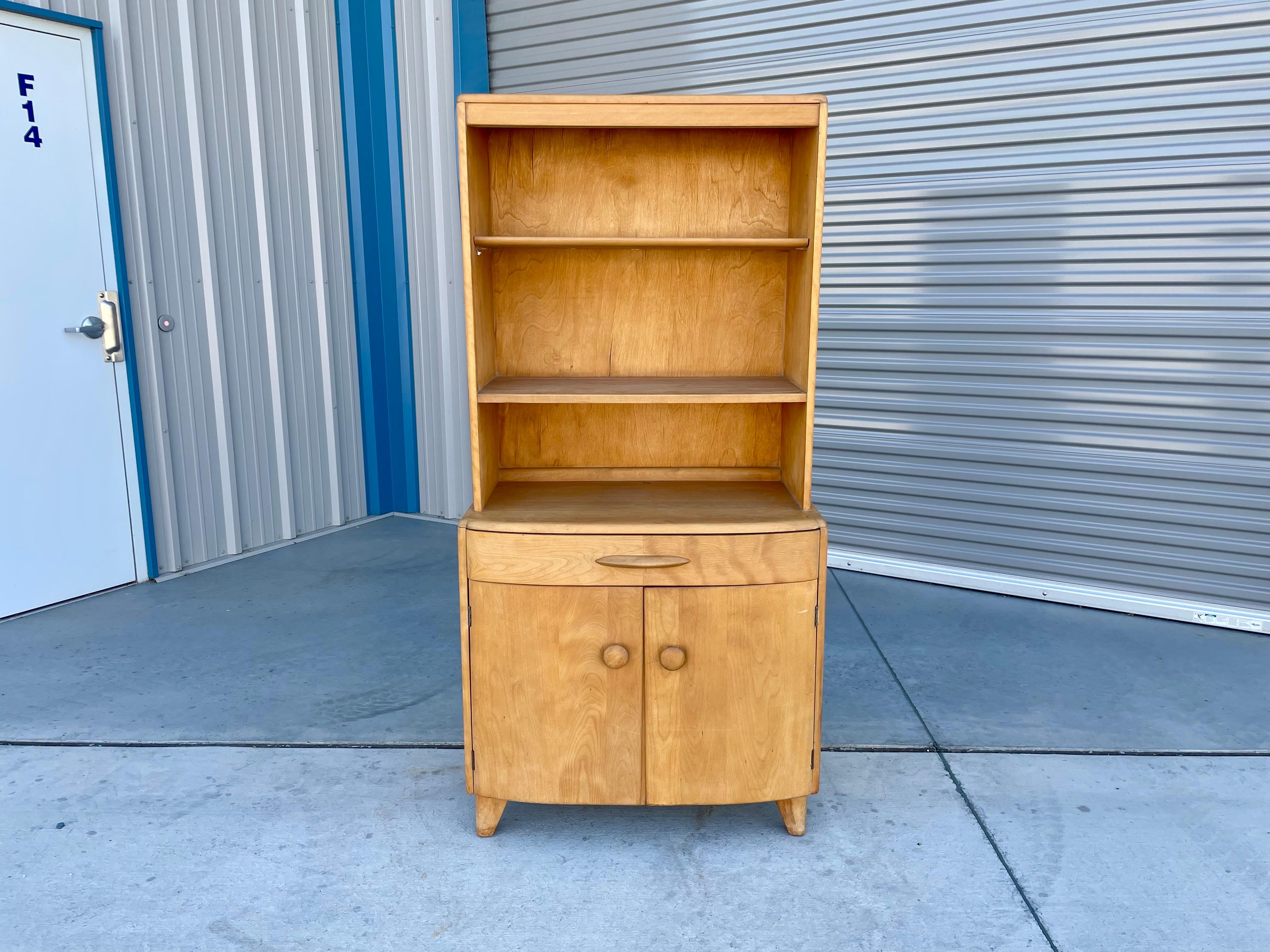 Mid-century cabinet designed and manufactured by Heywood Wakefieldcrica 1960s. This stunning cabinet features a maple frame that easily separates into two pieces, making it easy to transport. The bottom piece comes with one drawer, while the top