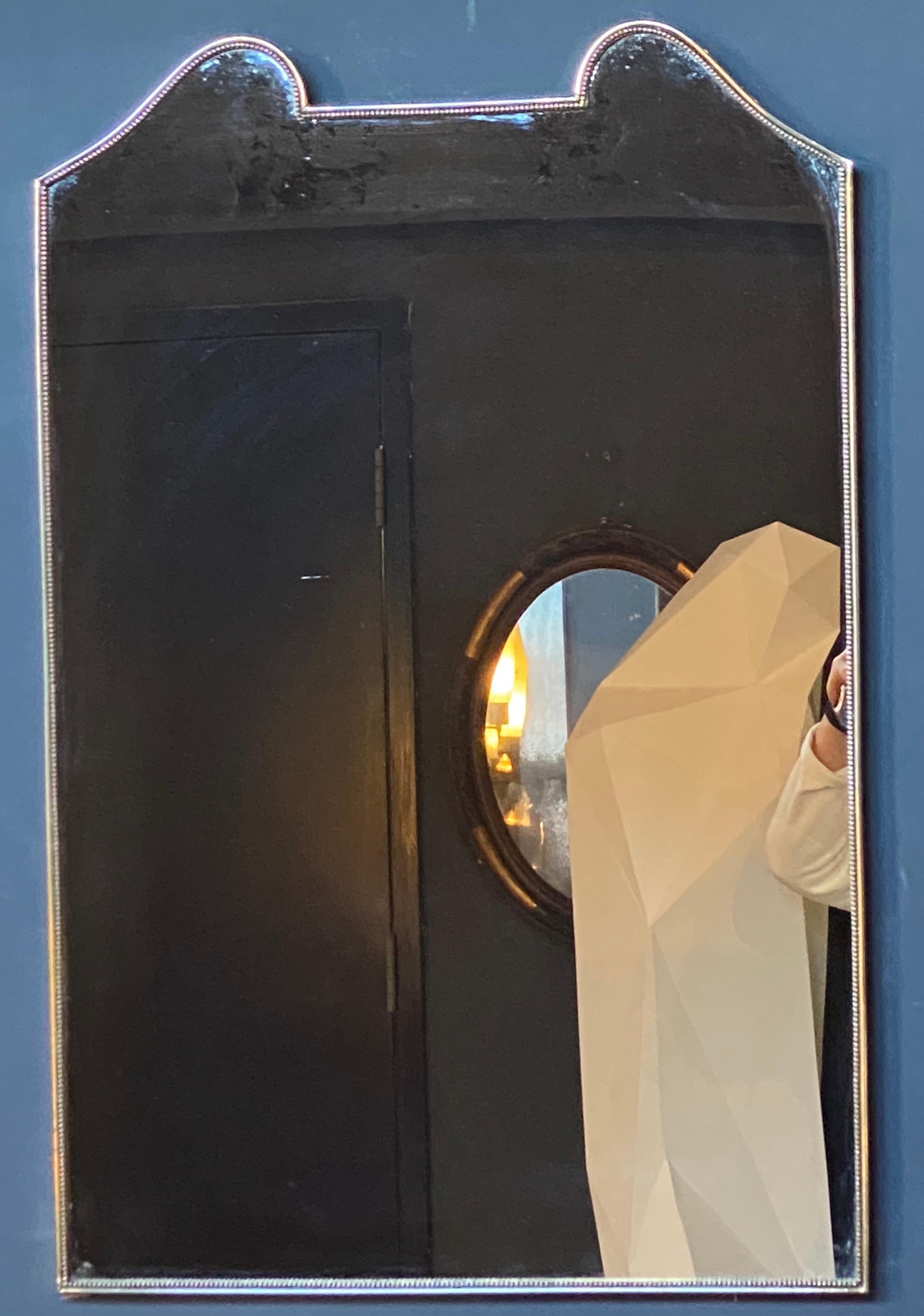 Beautiful sculptural Italian wall Mirror made with brass. The mirror has a beautiful and unique shape. An iconic piece that will complete a midcentury style living room or studio with its timeless elegance.
   