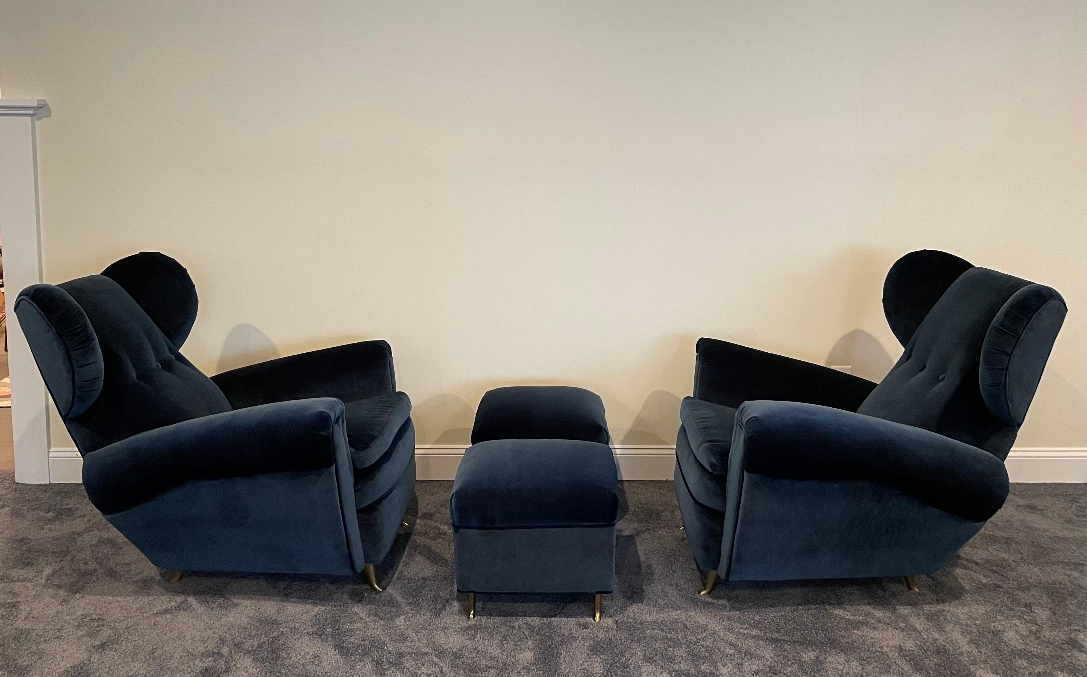 Incredible pair of mid-century Italian wingback chairs originally purchased from Donzella and newly upholstered in deep blue mohair with matching ottomans. Chairs are as comfortable as they are elegant. All legs are hand-casted and solid brass.
